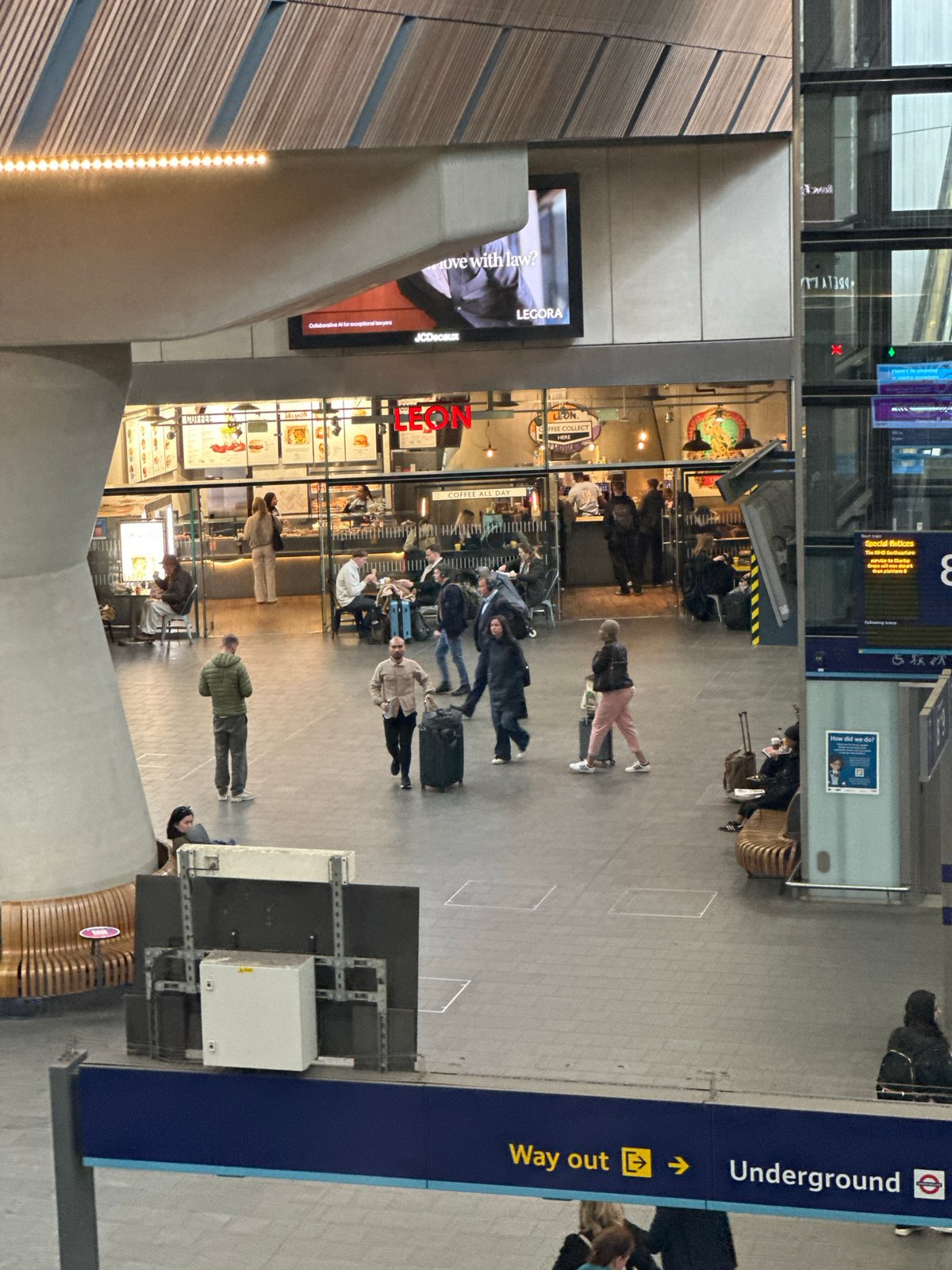 London train station bustling with travelers carrying luggage
