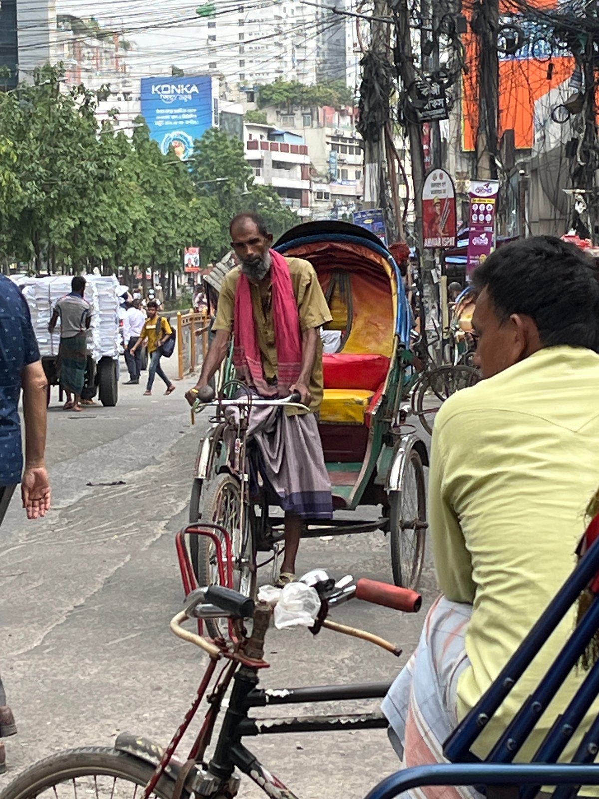 Colorful rickshaws navigate morning streets in Dhaka, Bangladesh