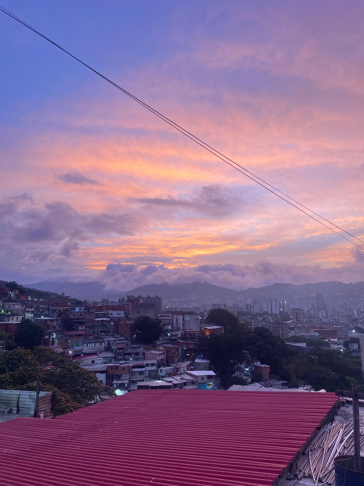 Dramatic sunset colors captured over Caracas cityscape