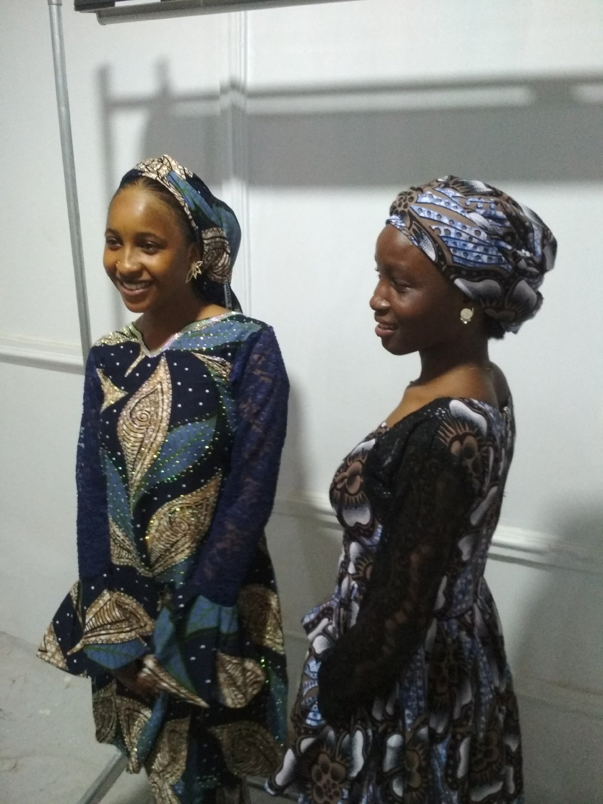 Women in traditional dress photographed during indoor gathering session