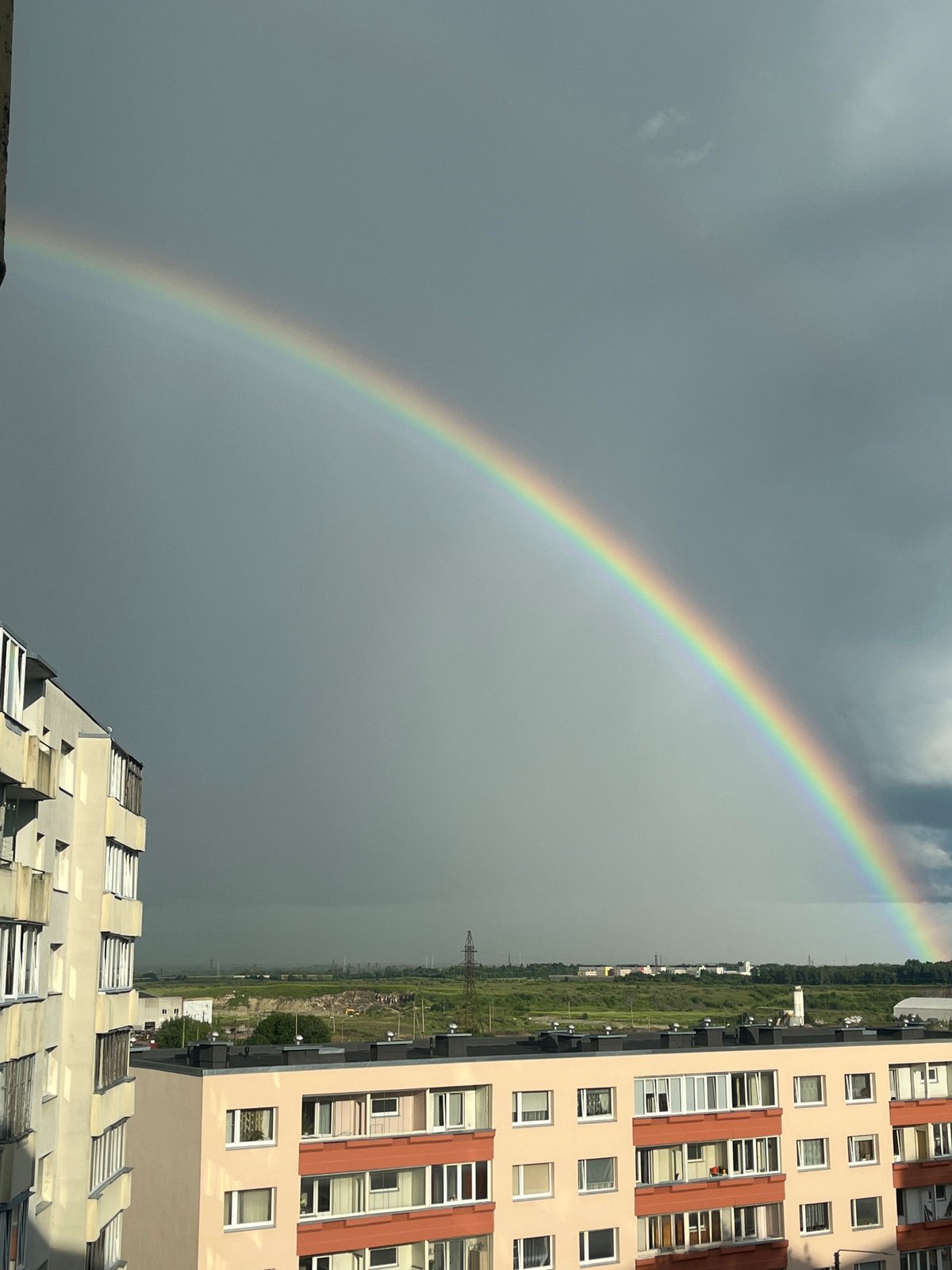 Bright rainbow over Tallinn's skyline on a grey afternoon