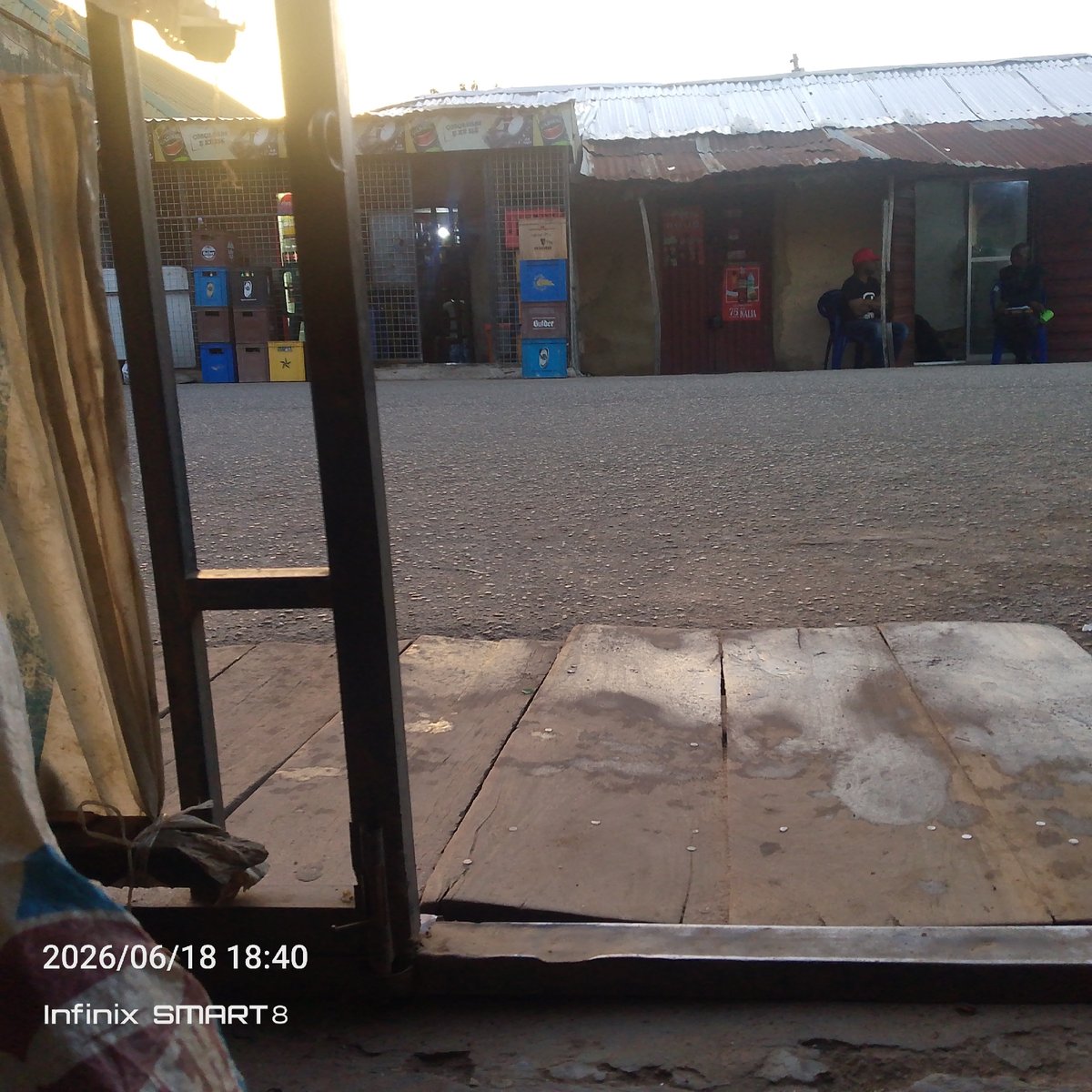 Outdoor worksite and market hangout, with a device booting up nearby.