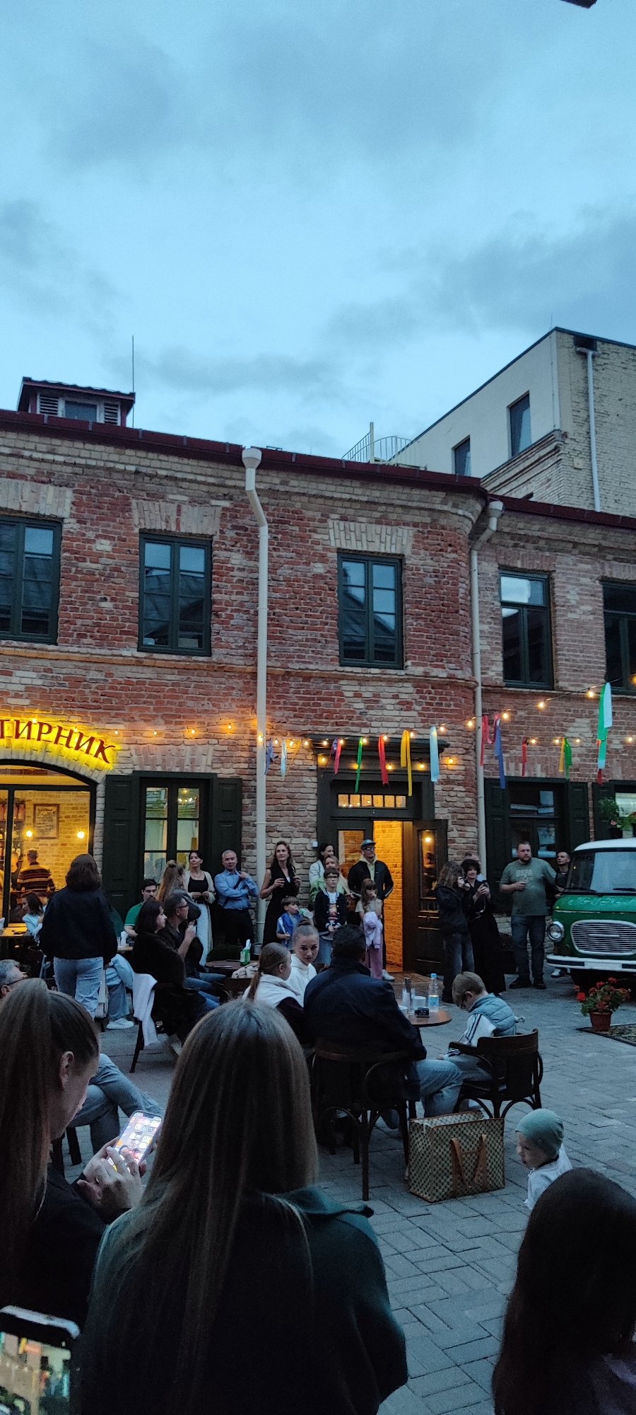 Live acoustic set in a Hrodna courtyard venue, evening.