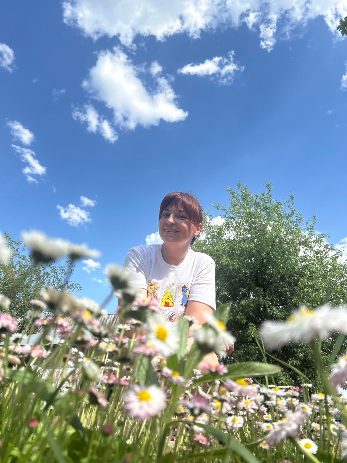 Woman poses in blooming daisy field in Russia