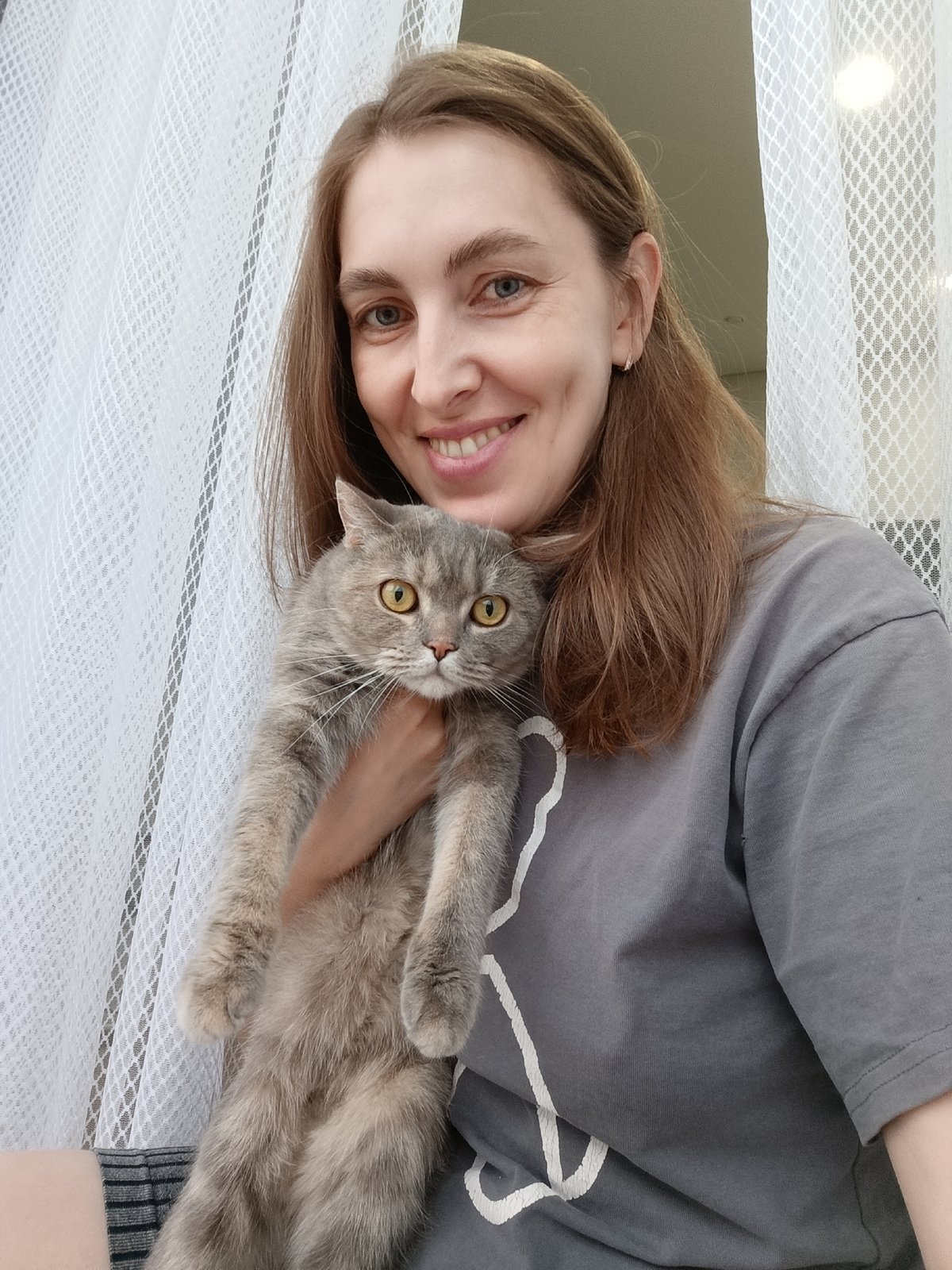 Woman photographed with cat and art project in Chaikovsky