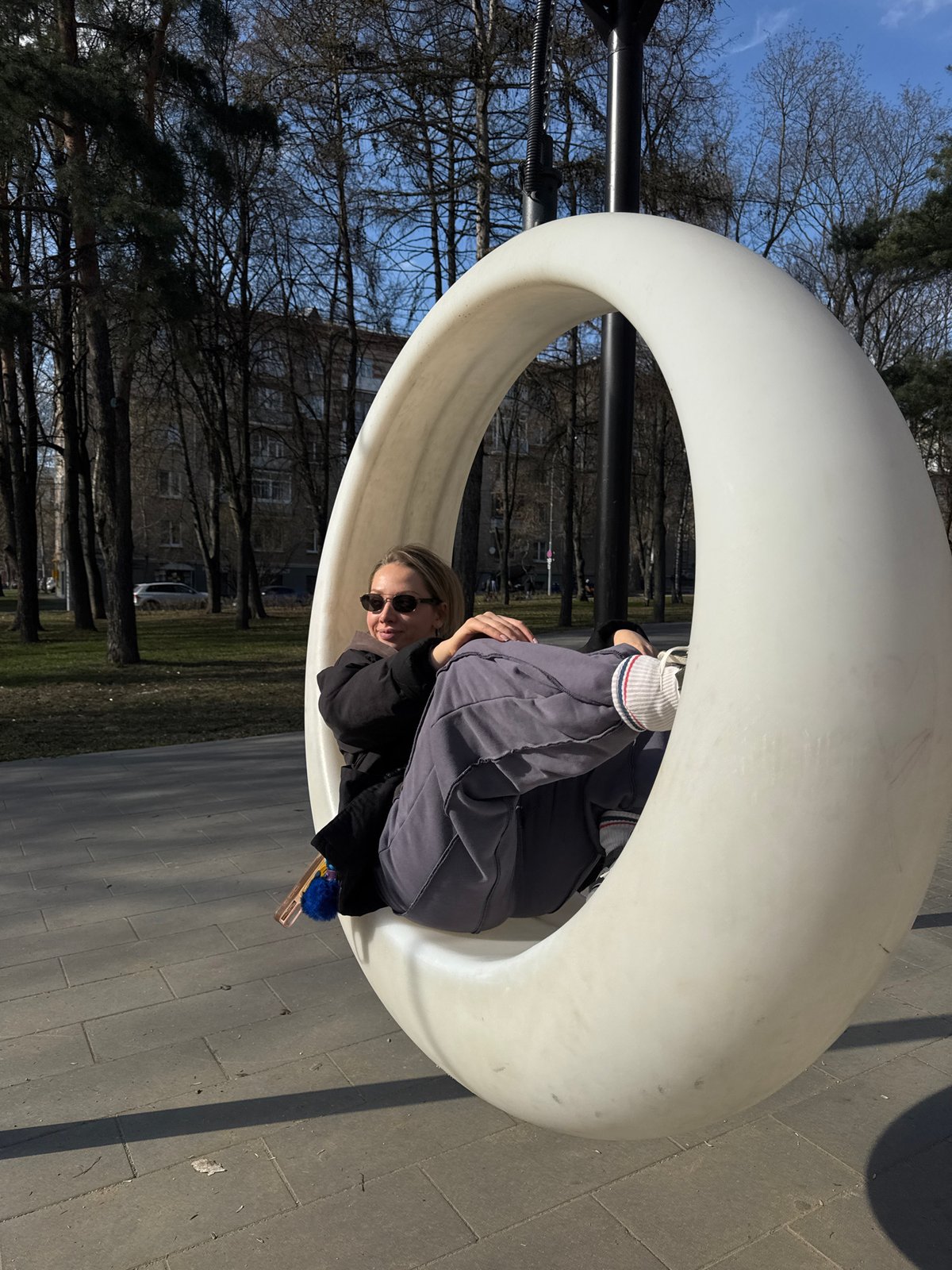 Woman enjoys spherical swing at Moscow park playground