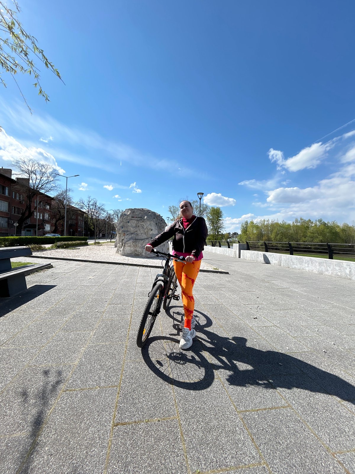Cyclist spotted near climbing boulder in sunny Plovdiv afternoon