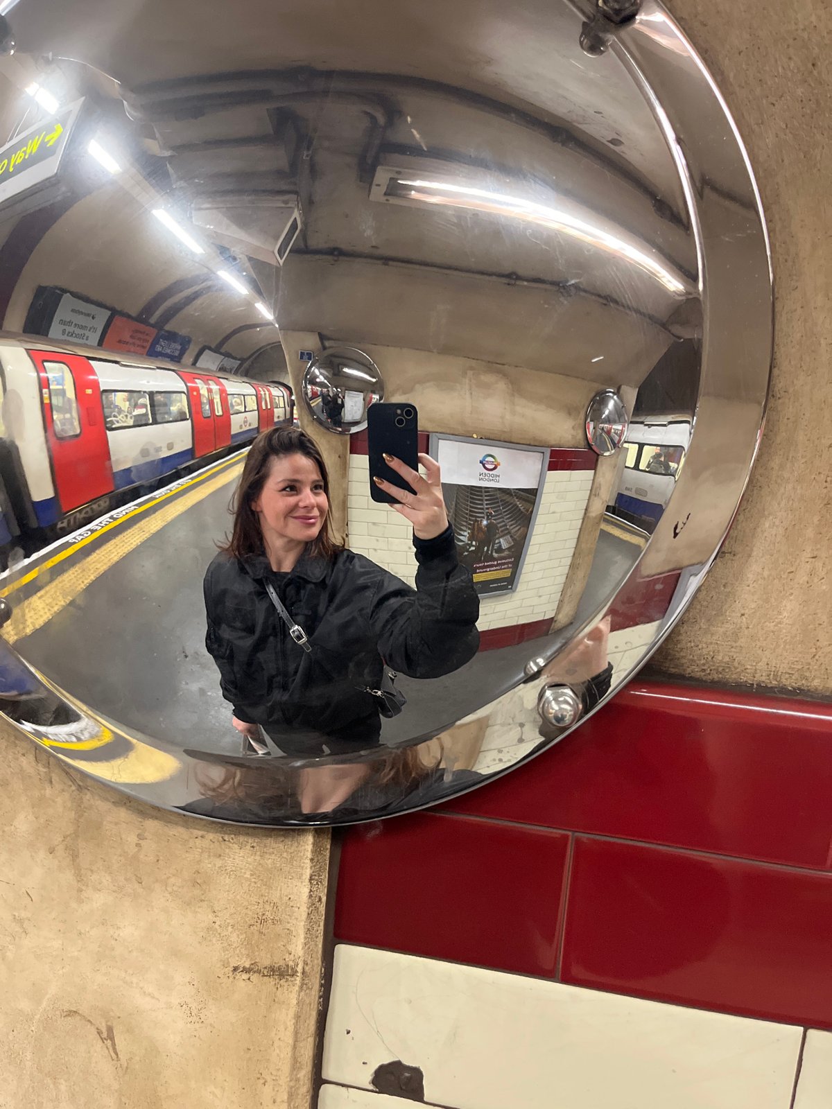 Commuters pose for photos at London Underground station