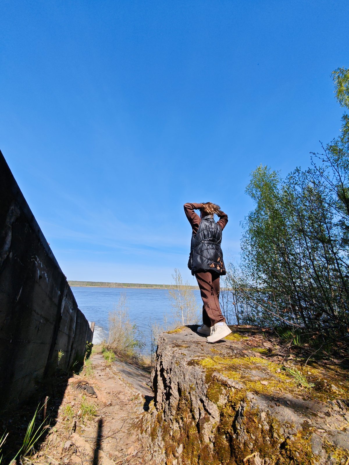 Woman documents dam spillway visit in Chernushka, Russia
