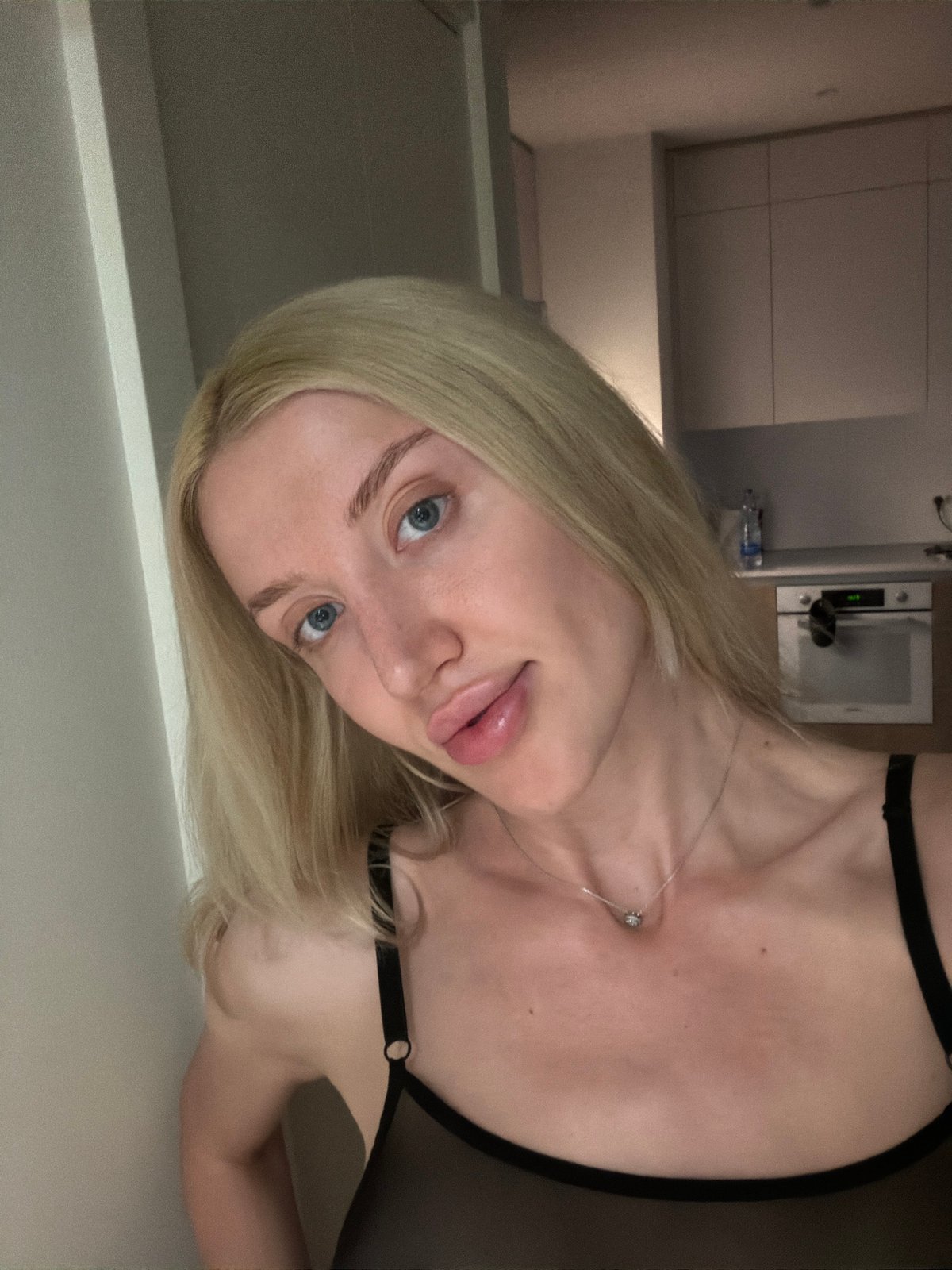 Woman photographed posing indoors in Belgrade residential setting