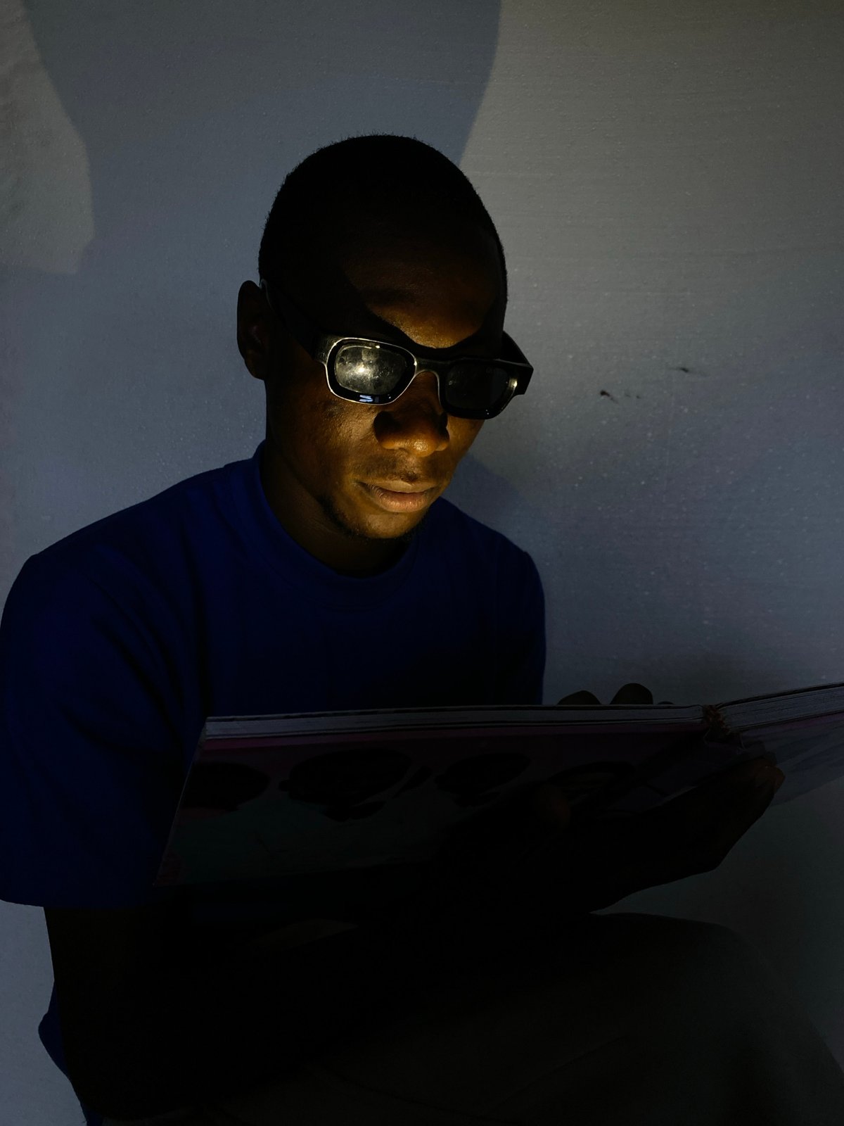 Reading a book in low light, caught in two angles