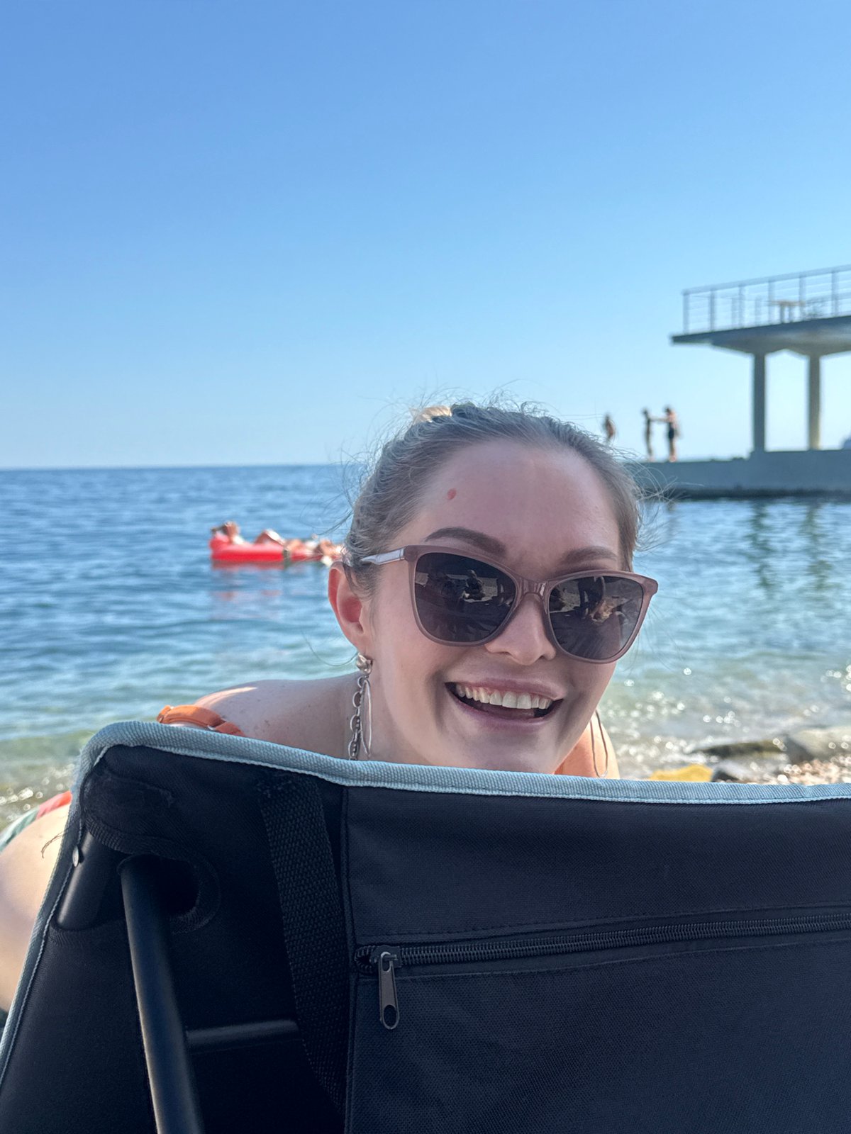 Summer day at Utios beach: swimming, sunbathing, and clifftop views