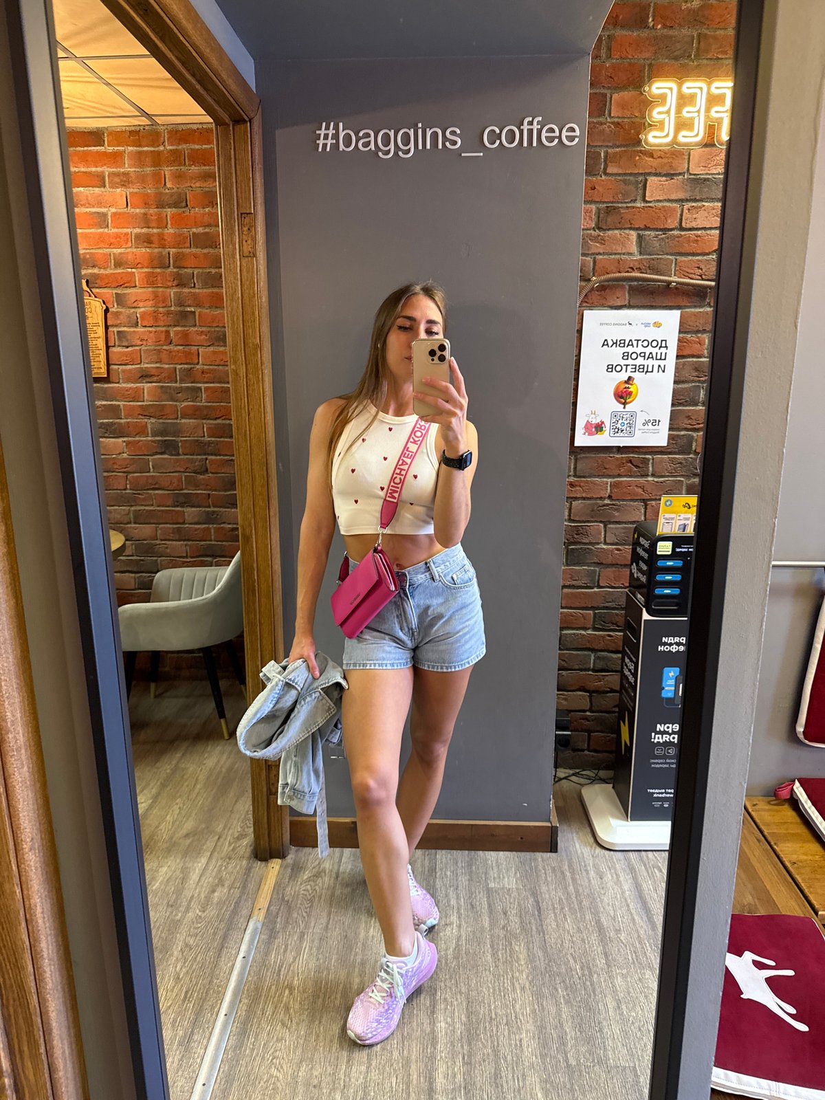 Mirror selfie in a Saint Petersburg café, heart-print outfit