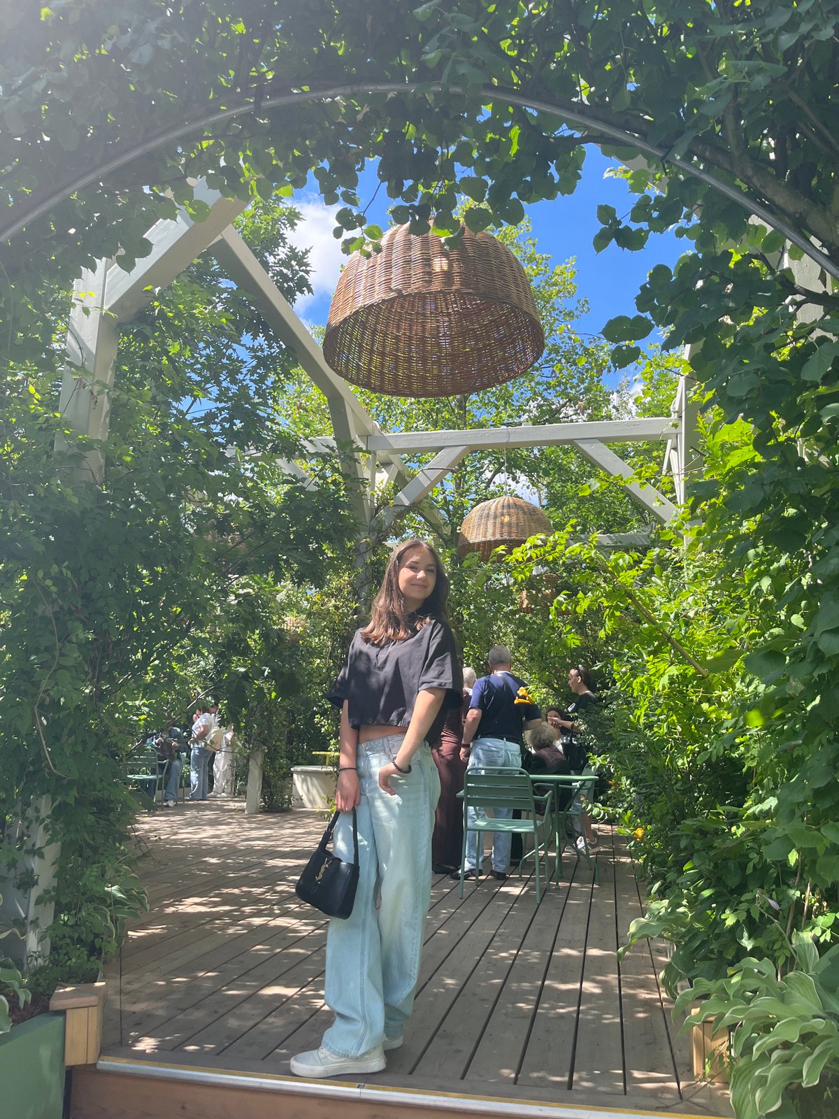 Moscow garden in full summer bloom, roses and boardwalks