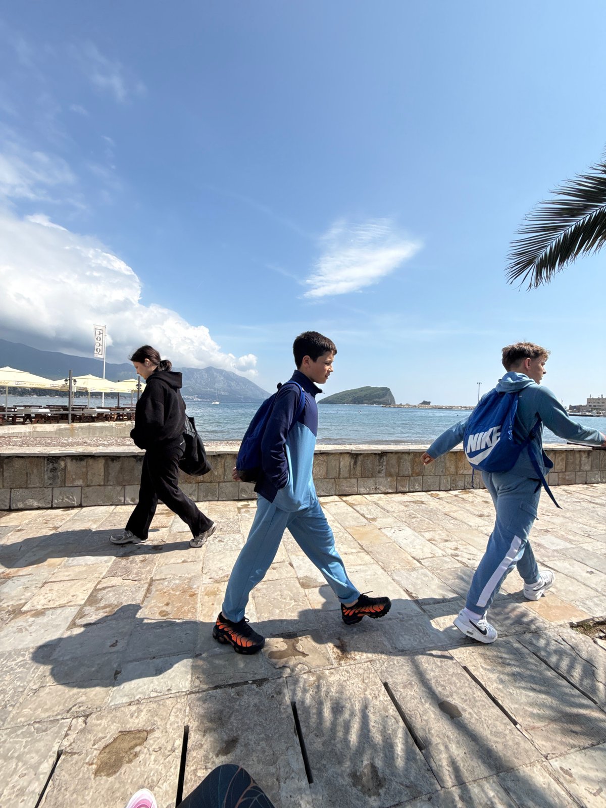 Sunny day brings visitors to Budva's scenic waterfront promenade