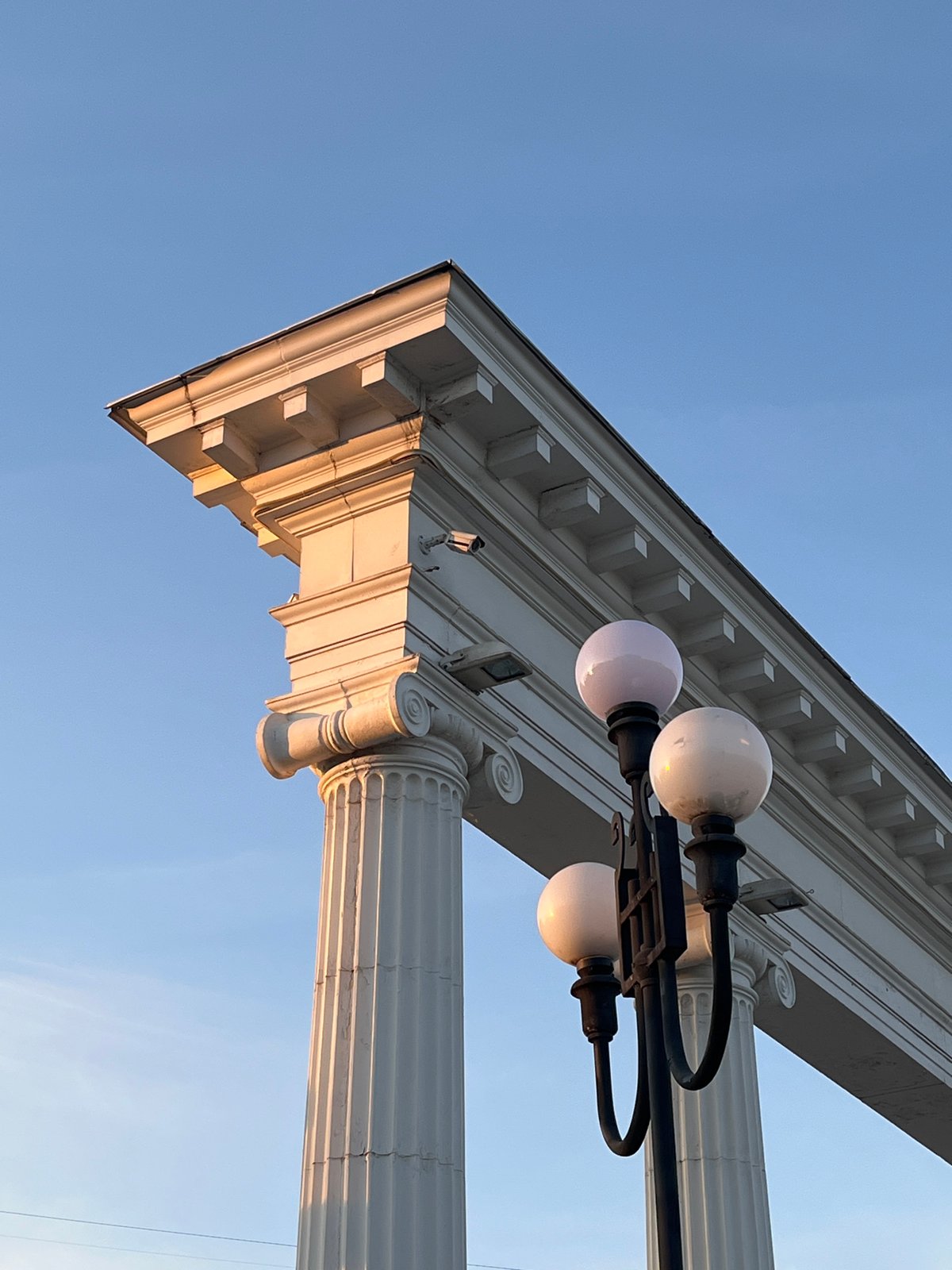 Classical column photographed from unusual angle against blue sky