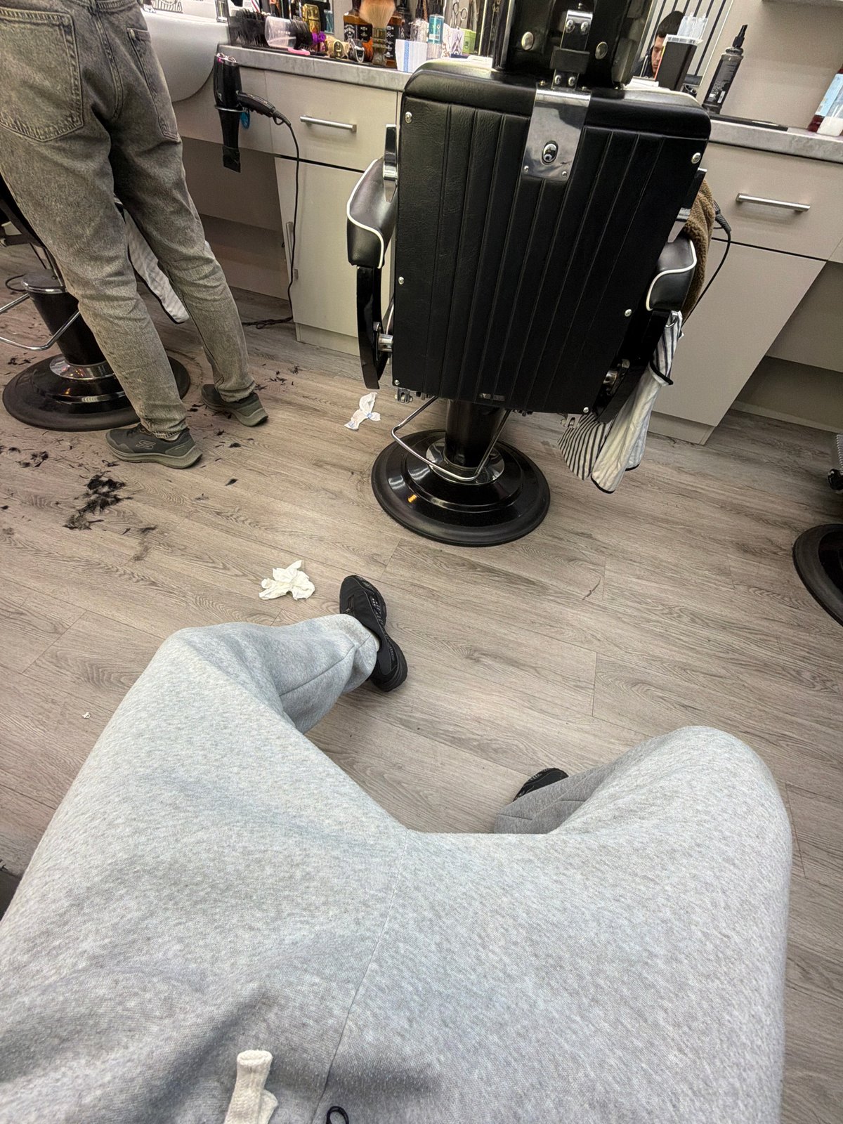Barbershop scene captured in London with two individuals present