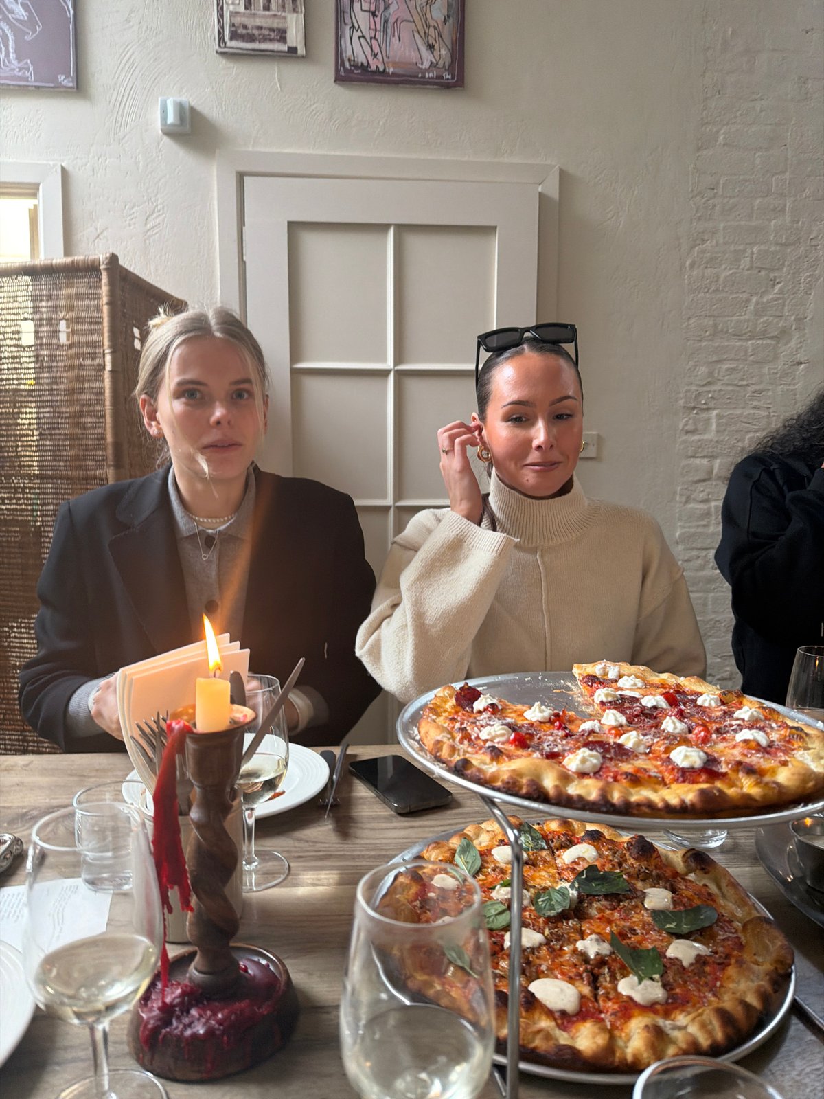 Women enjoy wine and photos during London restaurant gathering