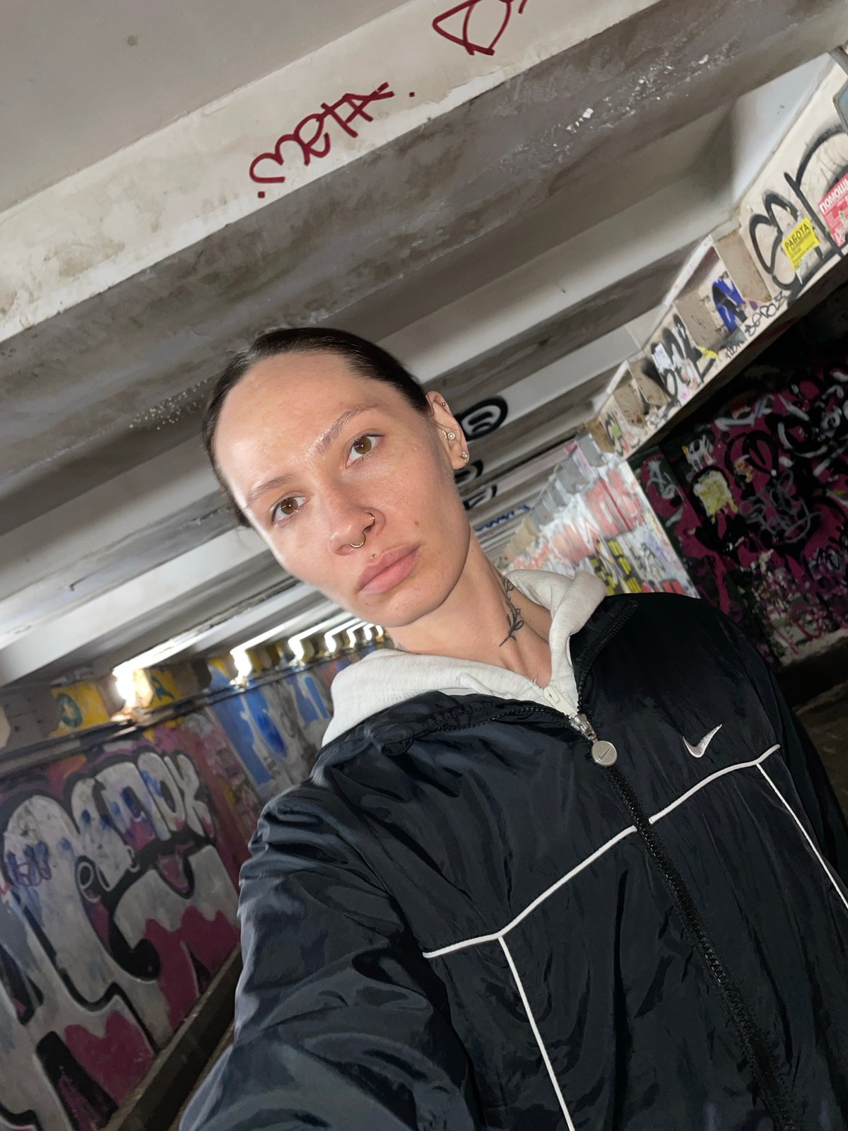 Person poses against graffiti wall in Izhevsk