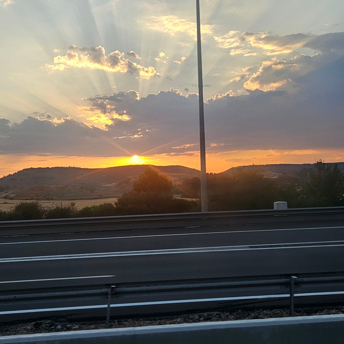 Orange sunset drops over the rolling hills of Medinaceli