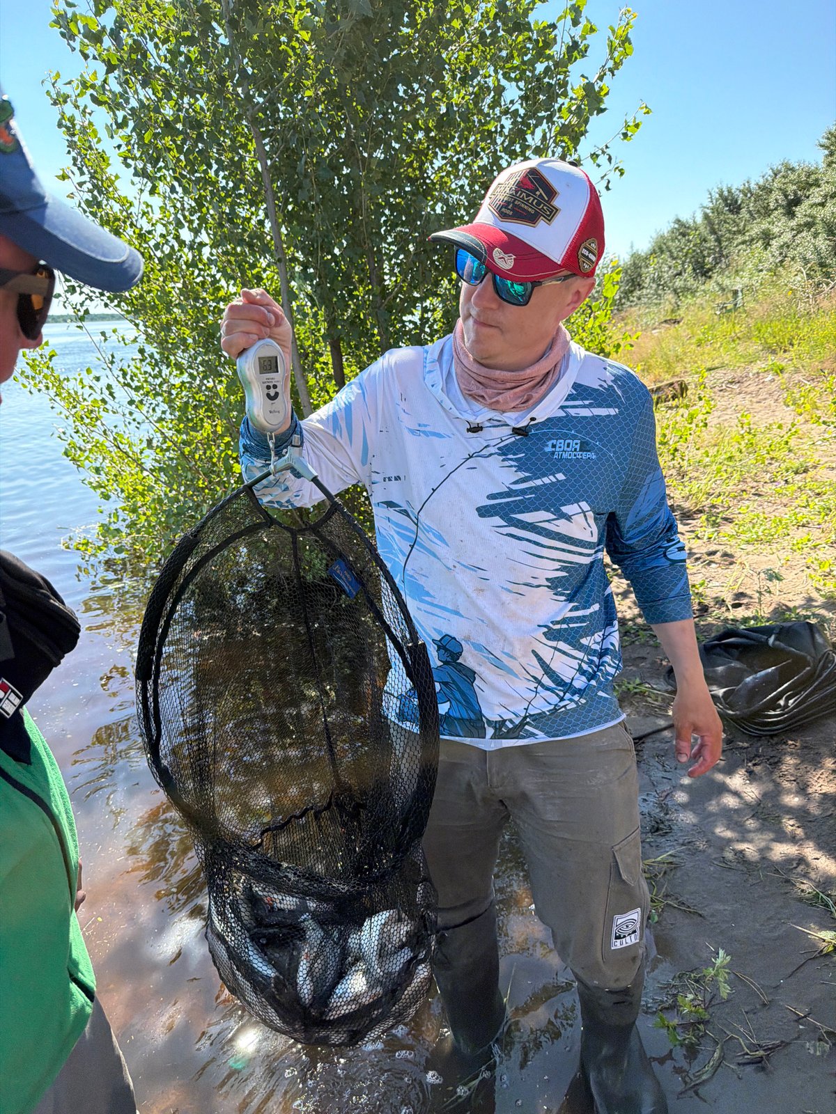 Fresh catch weighed at the water's edge in Tarasovo