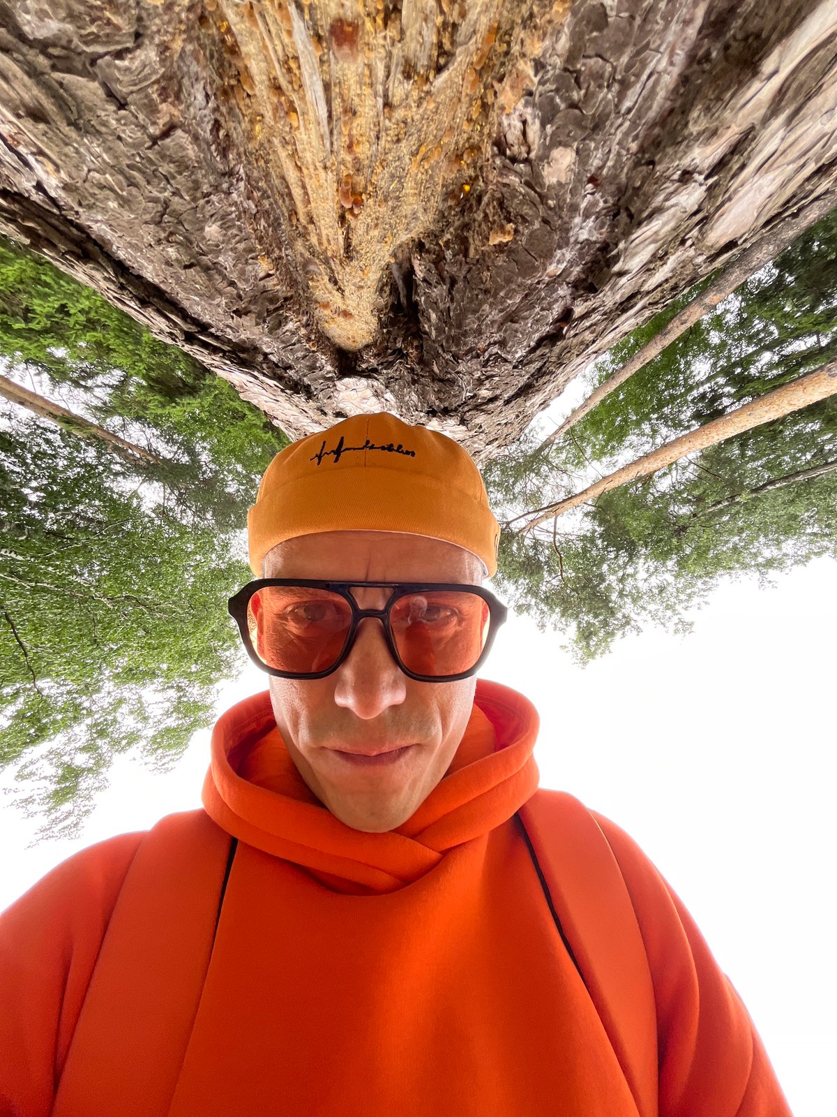 Person takes outdoor selfie in orange hoodie in Chaikovsky