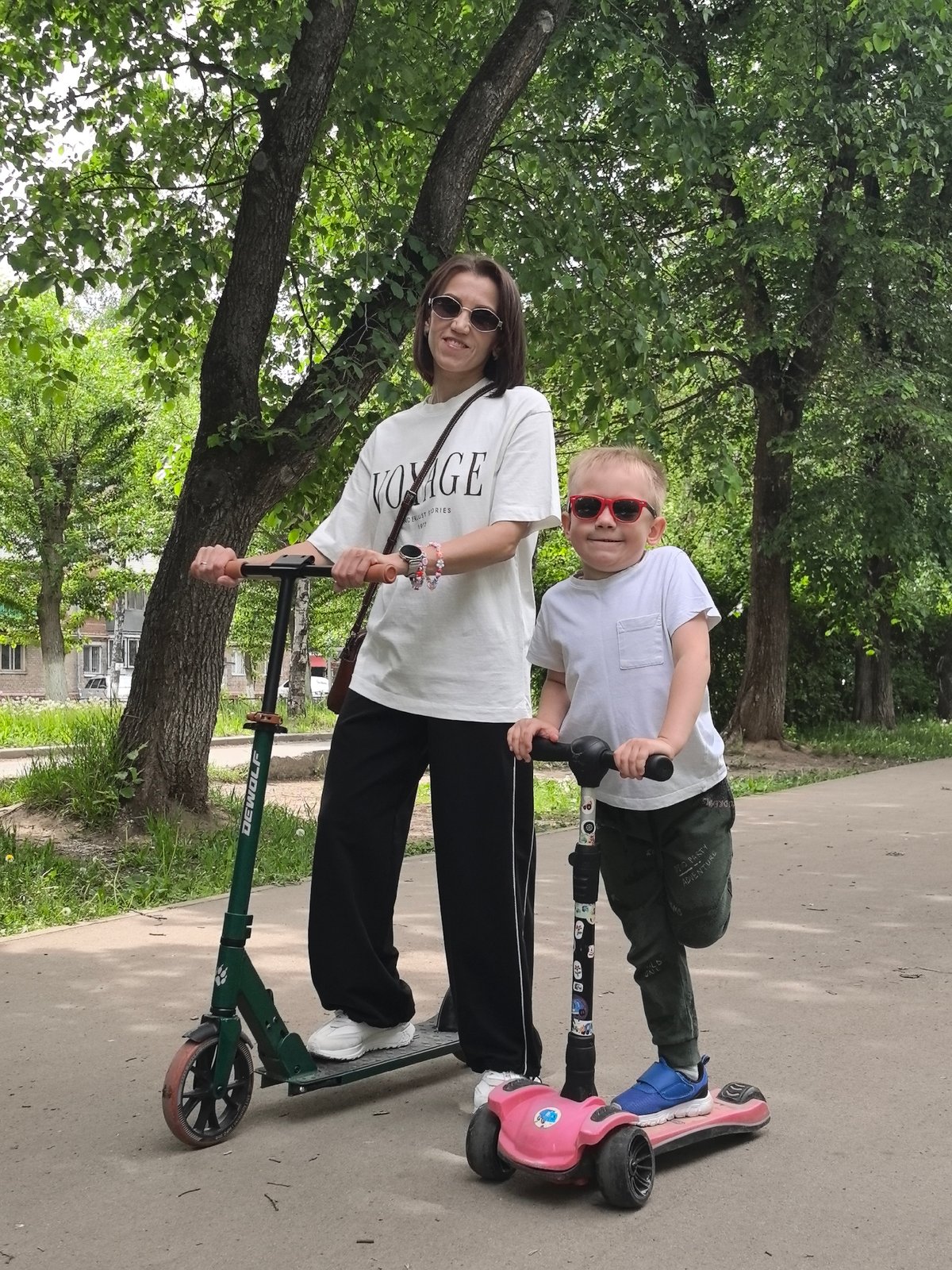 Mother and son pose with scooters in Perm
