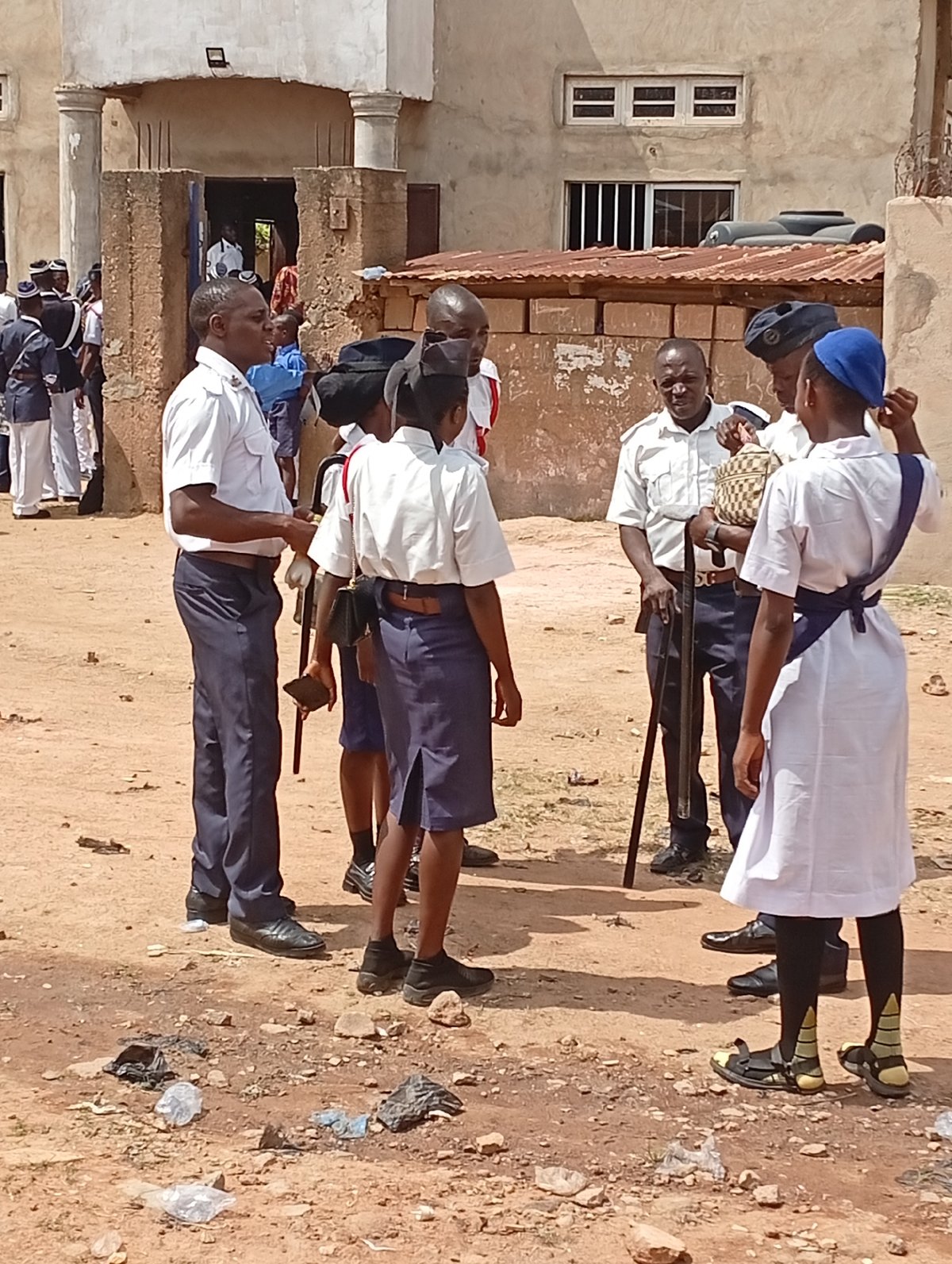 Uniformed personnel gather in outdoor formations during morning hours
