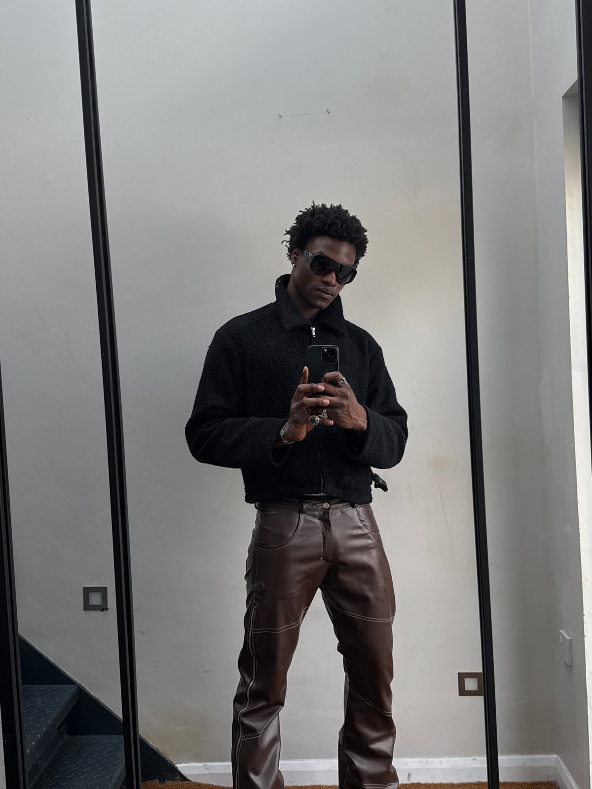 Person in sunglasses observed at mirror in London
