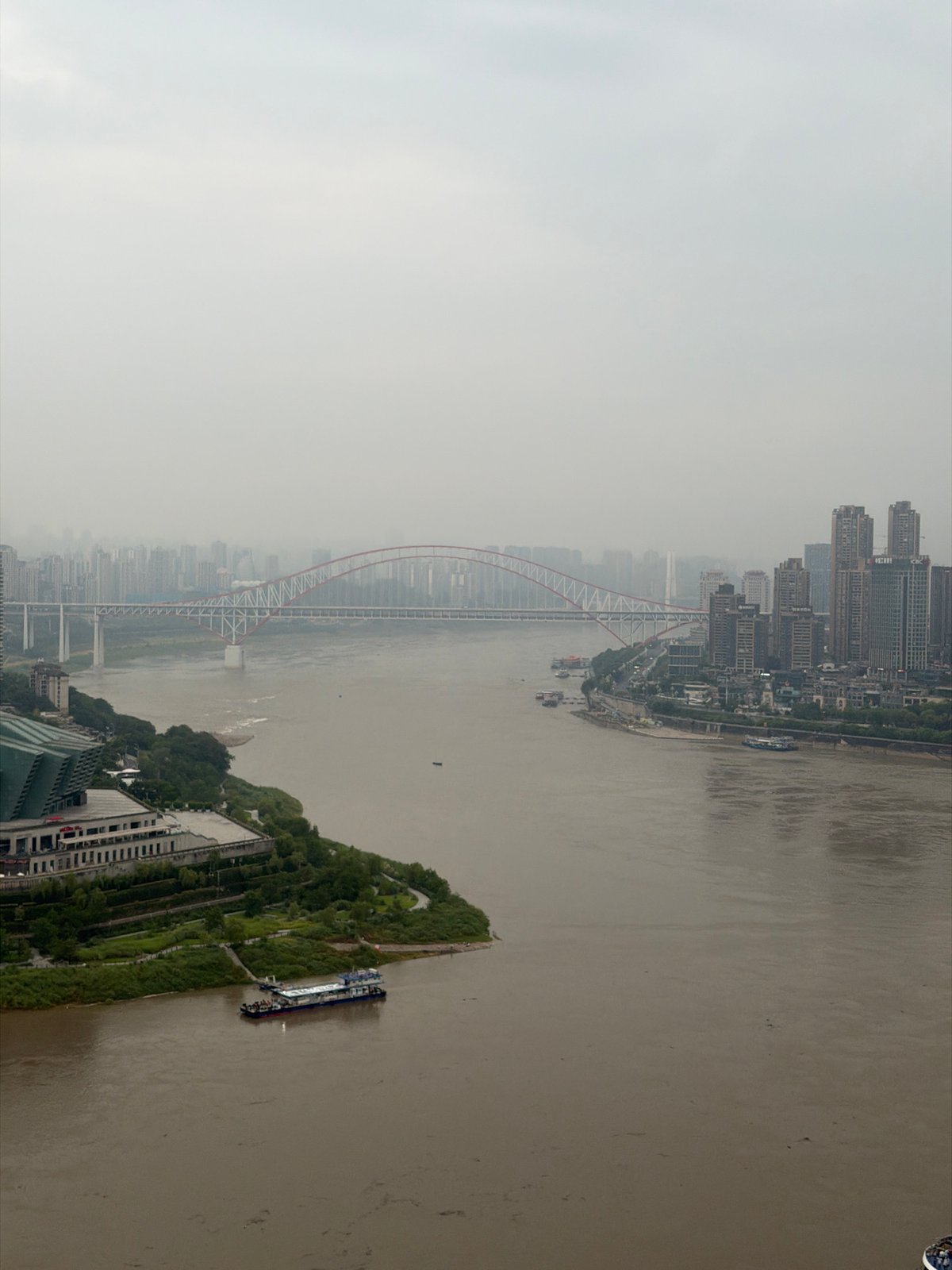 Chongqing's Yuzhong District skyline and riverfront on a cloudy evening