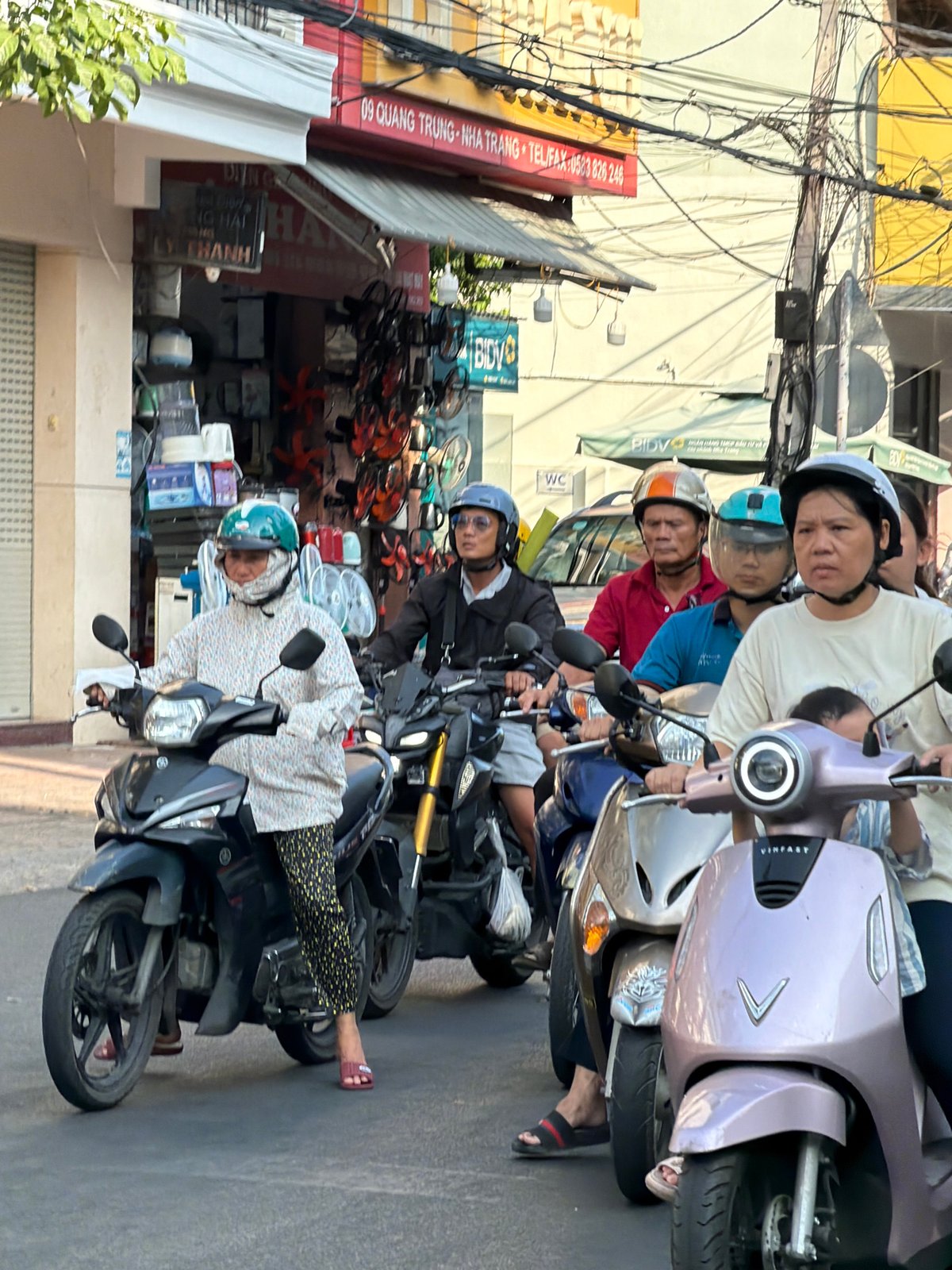 Morning motorcycle traffic flows through central Nha Trang streets