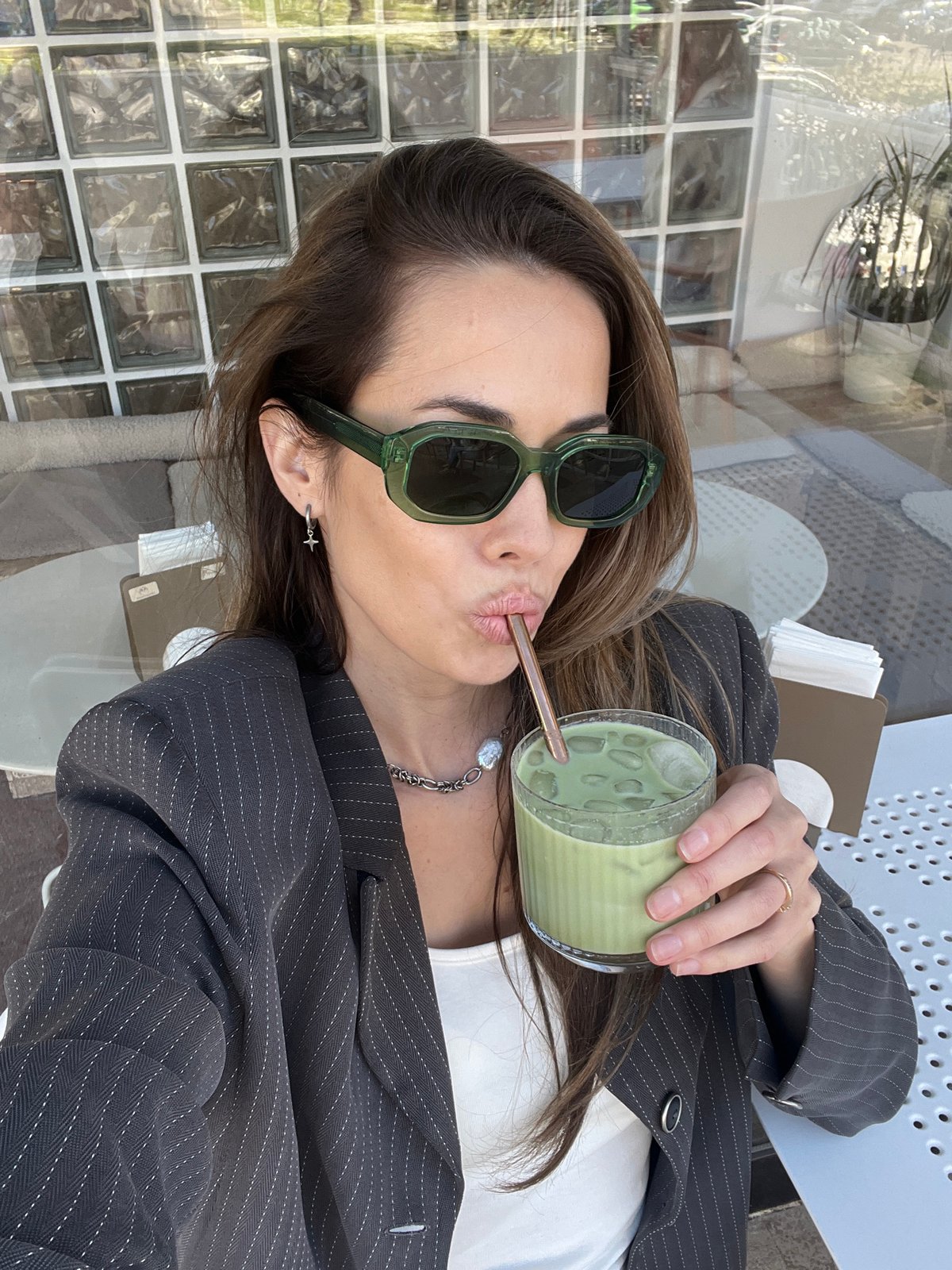 Woman enjoys matcha drinks at Montenegro cafe amid spring flowers