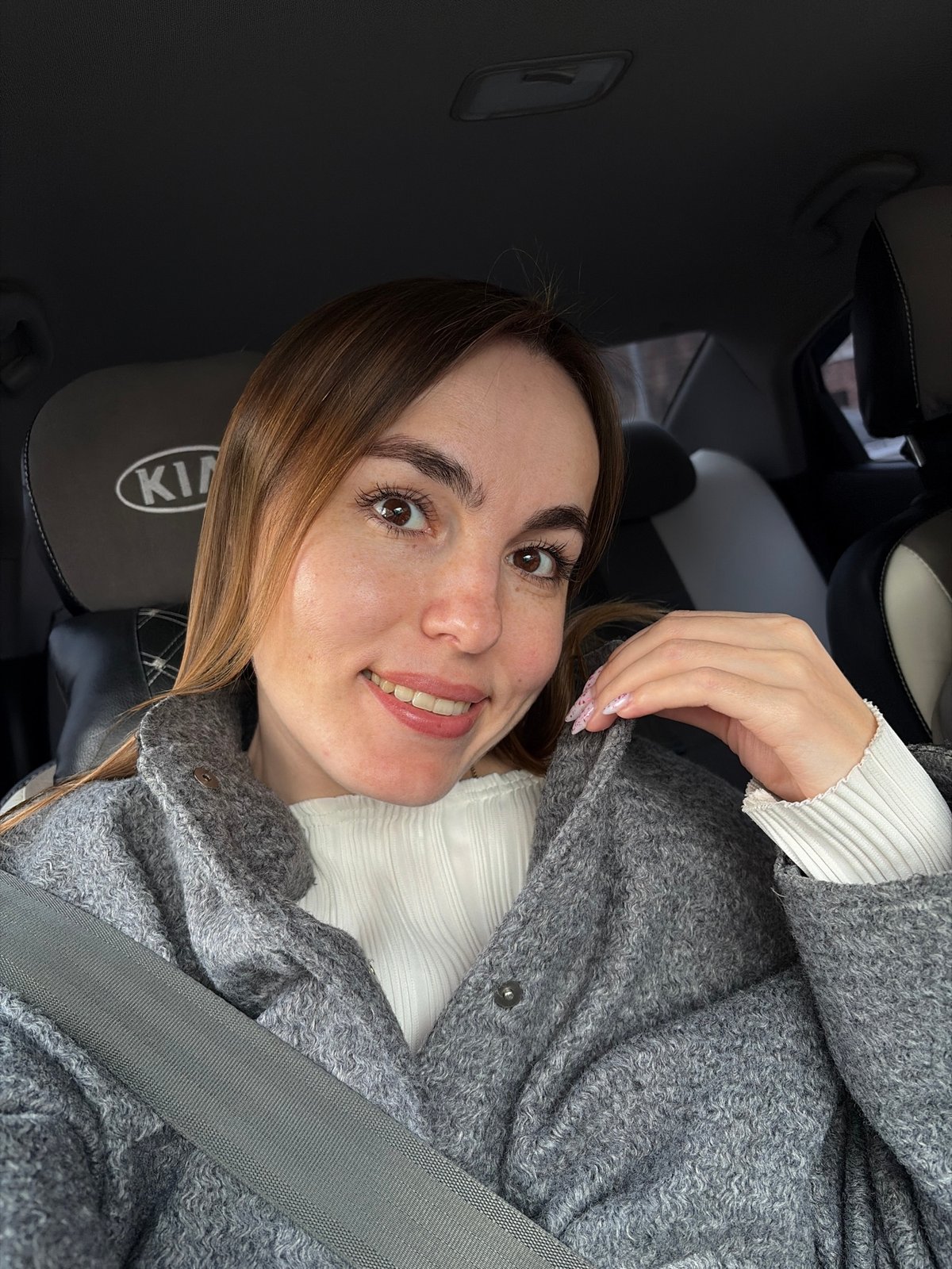 Woman takes selfies in Kia driver's seat in Izhevsk