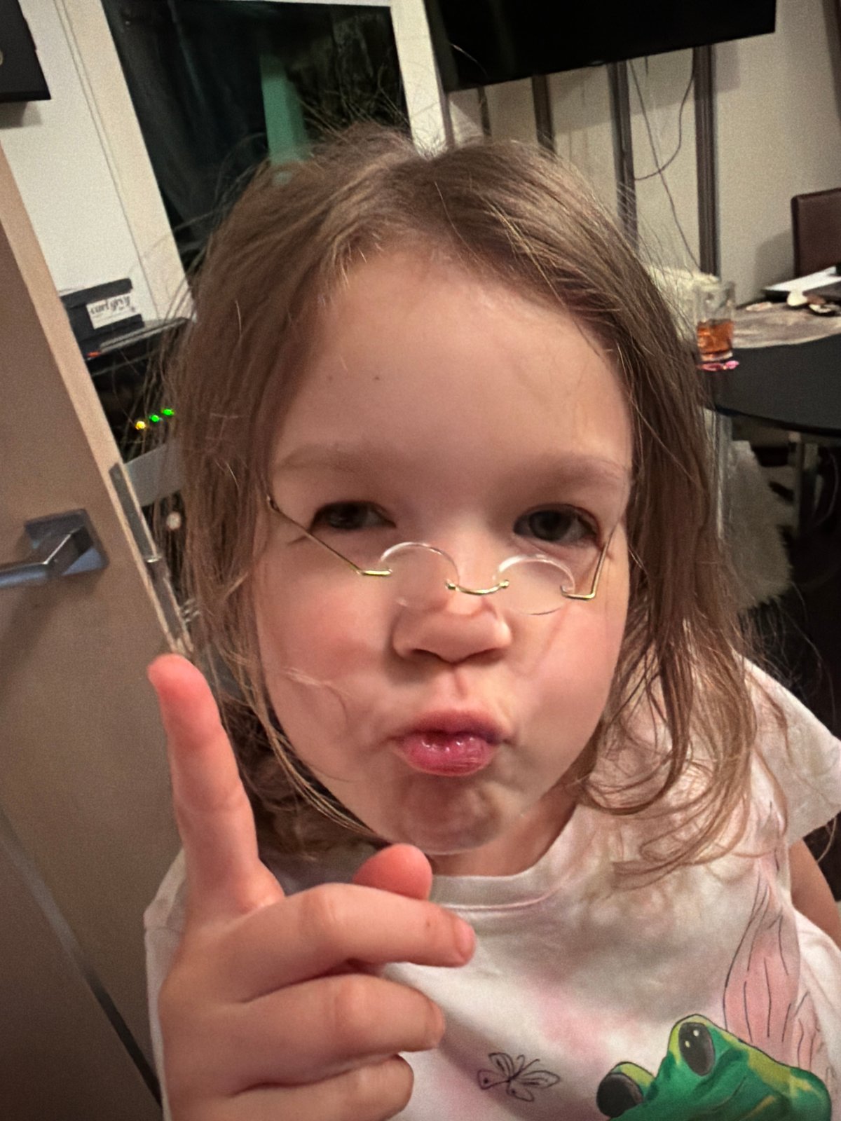 Girl makes pouting gesture while pointing in Saint Petersburg