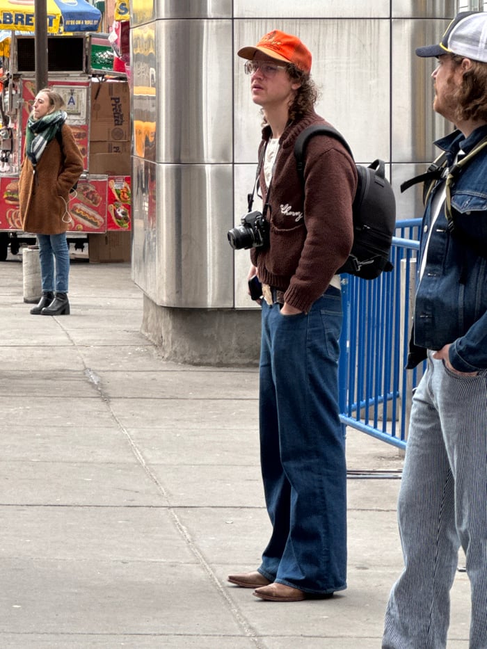 New Yorkers in winter clothes spotted outdoors, descending subway