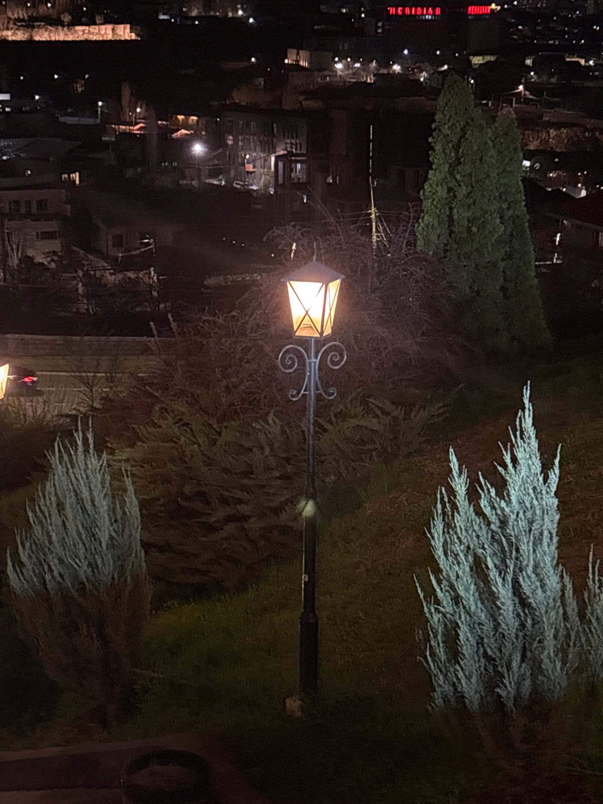 Illuminated Yerevan TV Tower displays colorful lights during evening hours