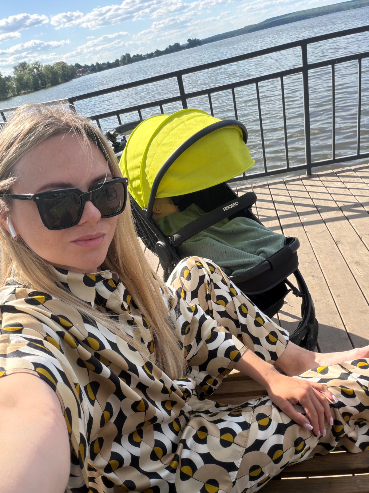 Woman with baby enjoys pier outing in Votkinsk, Russia