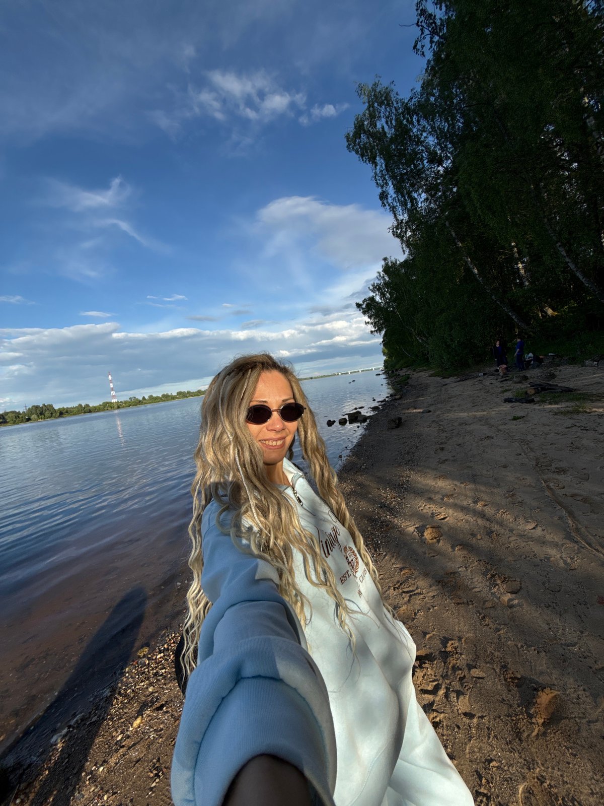 Woman takes selfie by water in Шебунино, Russia