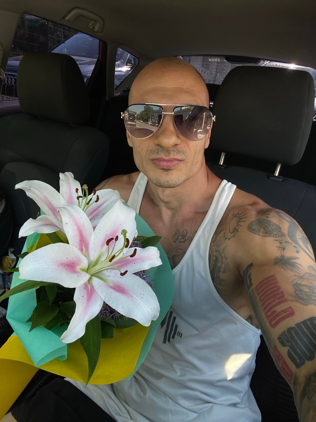 Parked in Pleven with a bouquet of lilies in hand