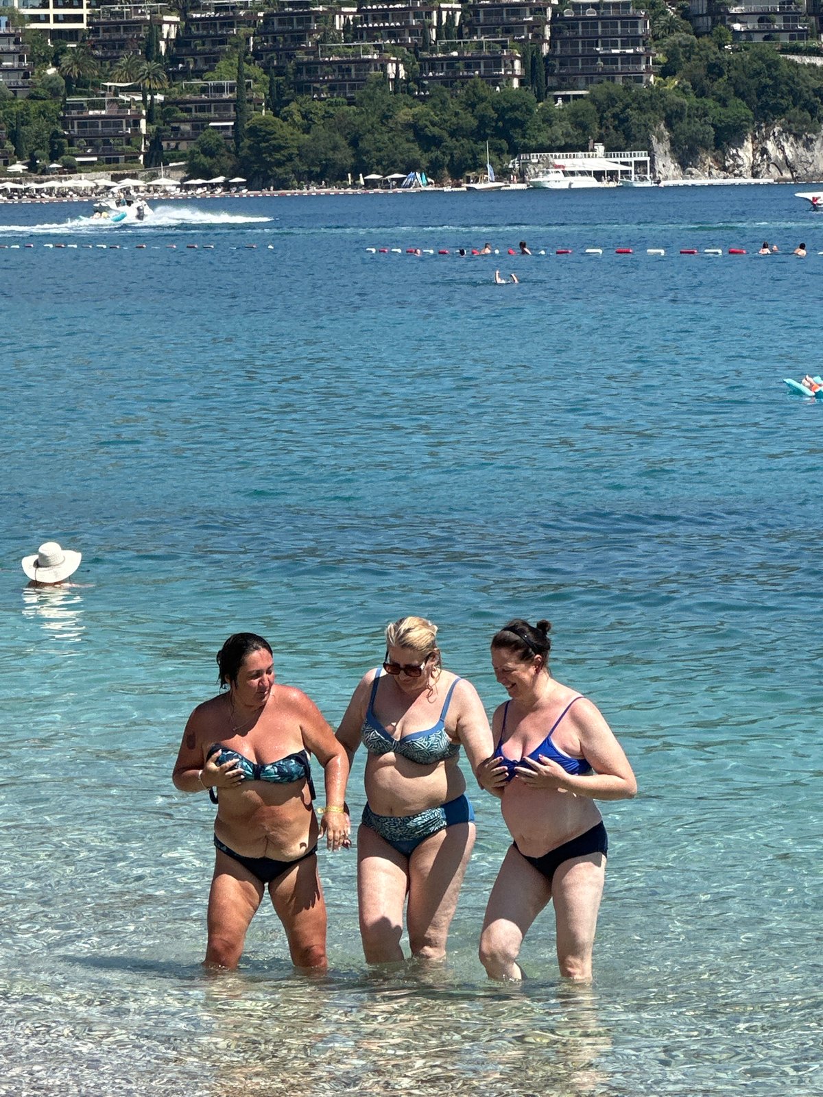 Summer beach day brings swimmers, parasailers to Budva coast