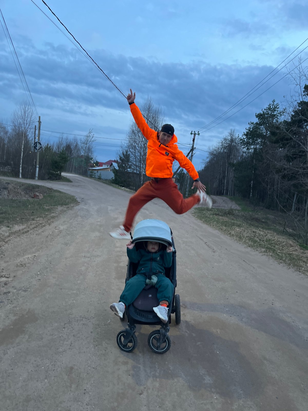 Family enjoys evening playtime on rural road in Chaikovsky