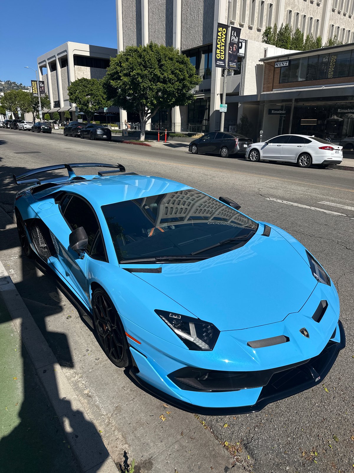 Luxury sports cars gather on Los Angeles street
