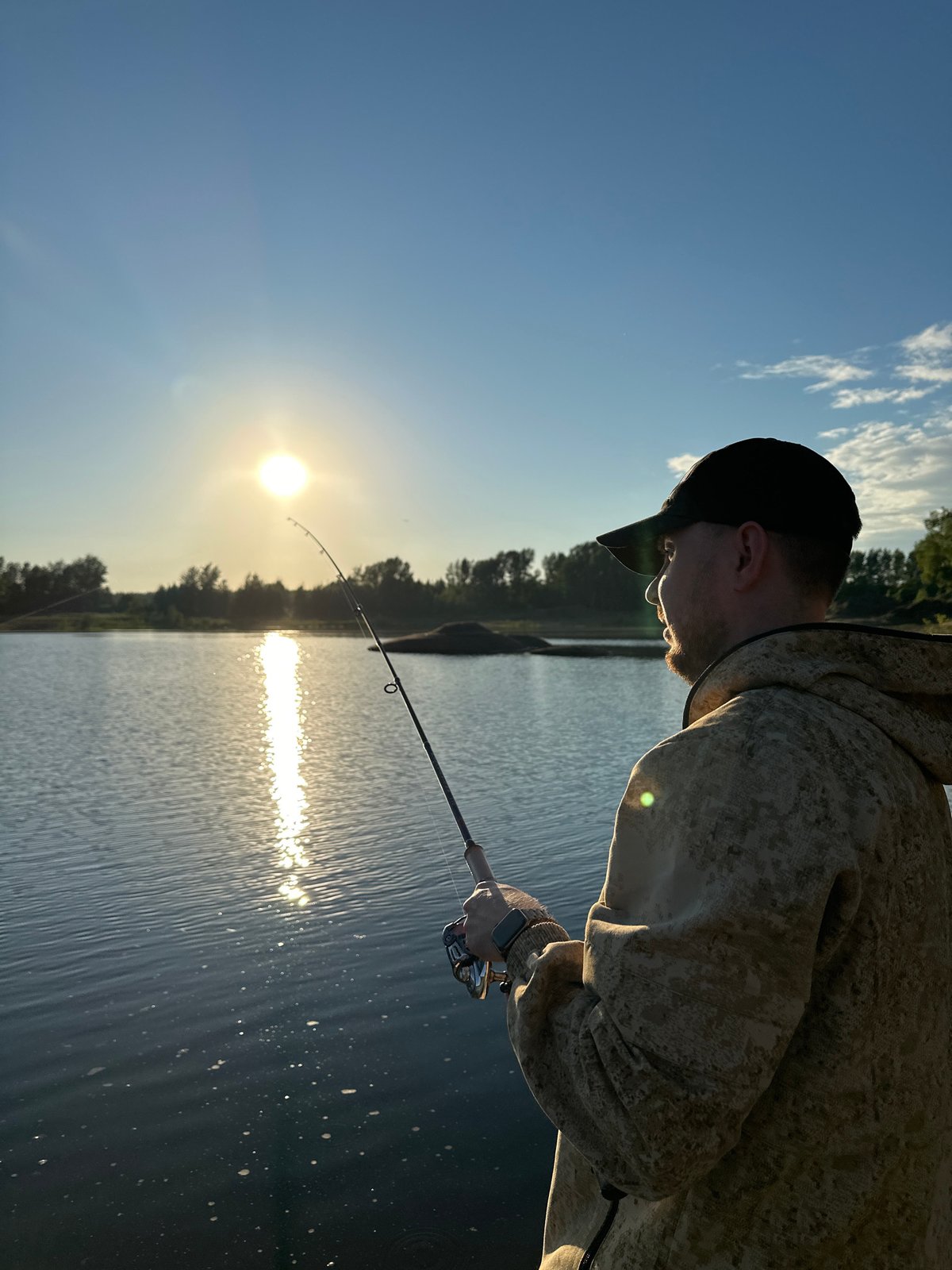 Evening fishing session on calm waters in Chaikovsky, Russia