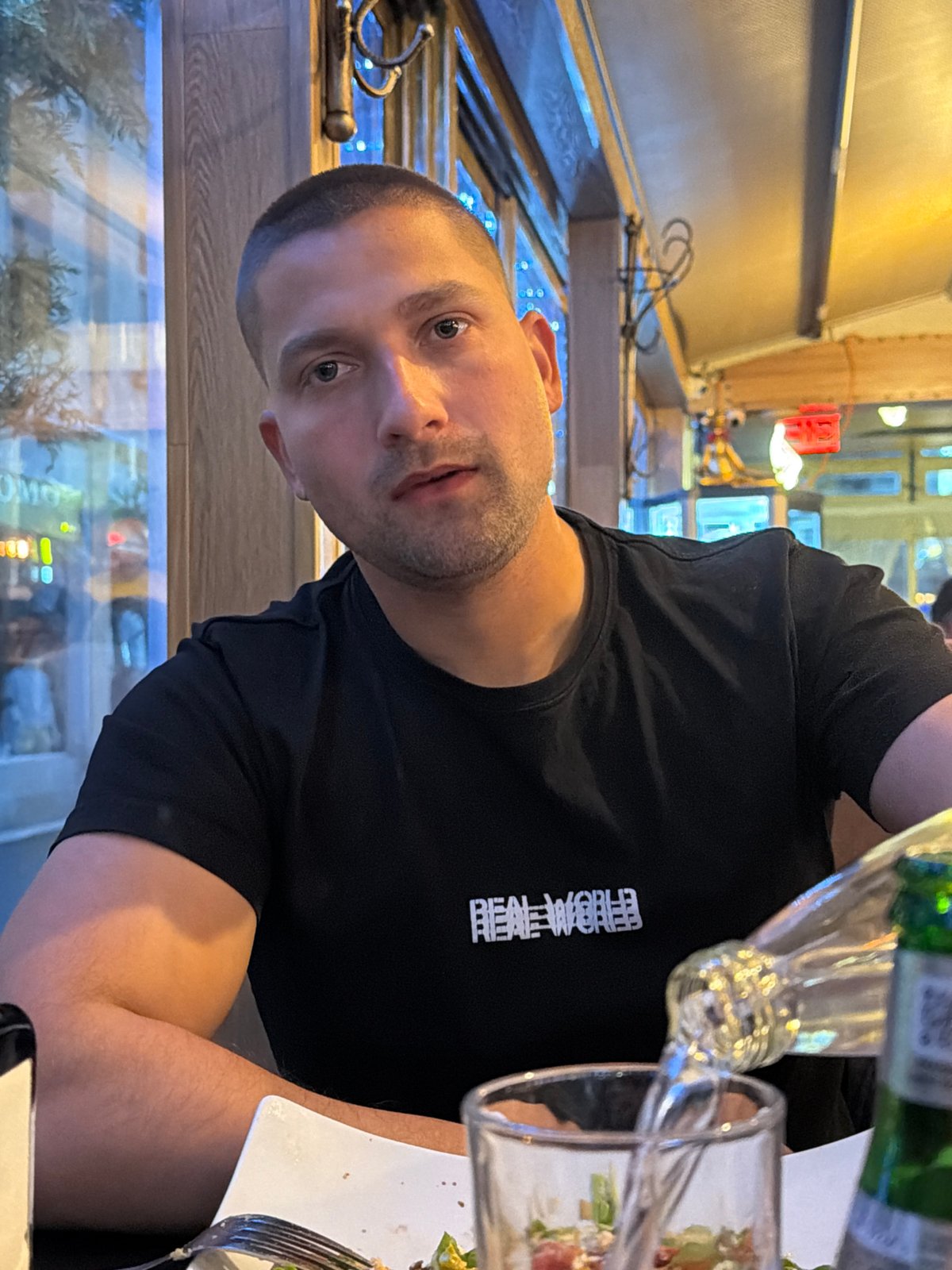 Man dines on sushi and salad at restaurant