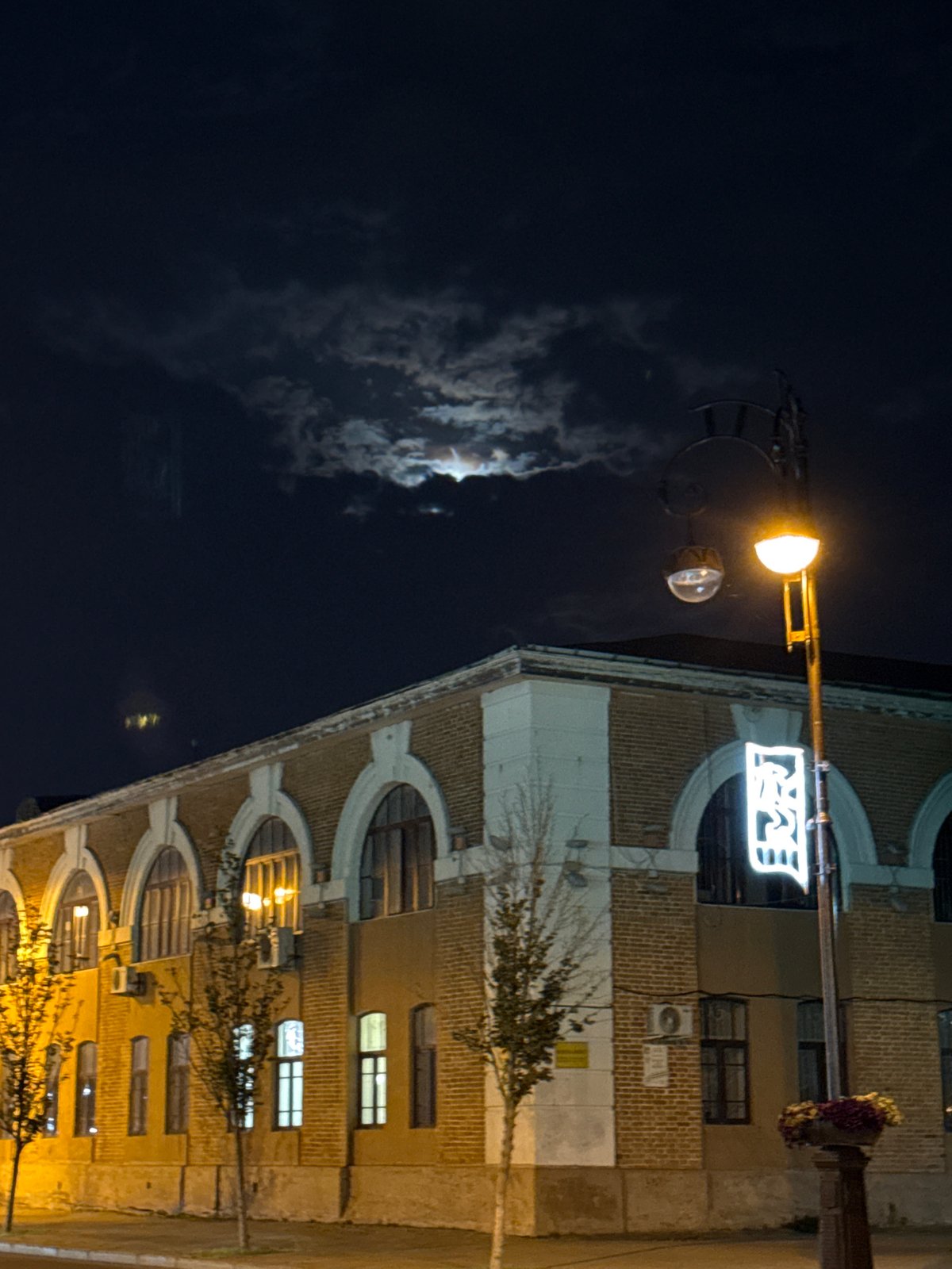 Tyumen's riverfront promenade lit up on a summer night