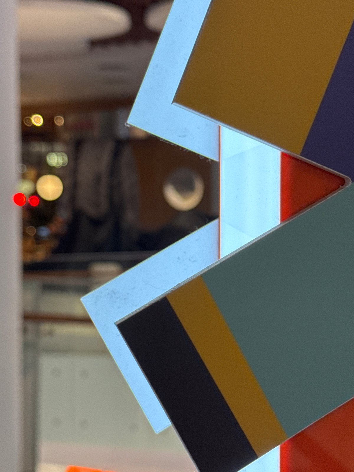Geometric displays and food hall signage observed in commercial building