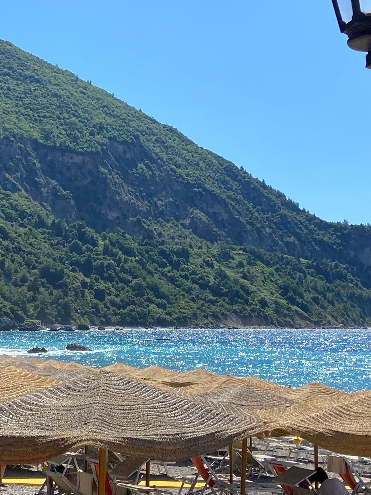 Beach day in Prijevor with thatched umbrellas and mountain views