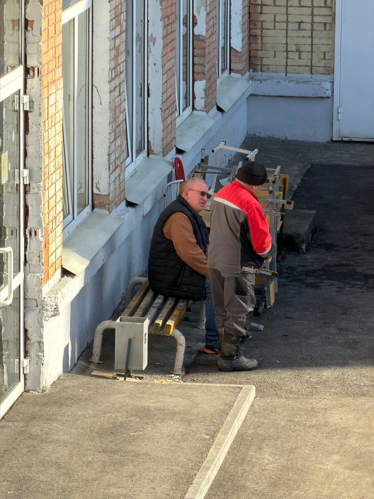 Construction workers perform exterior building work in Izhevsk