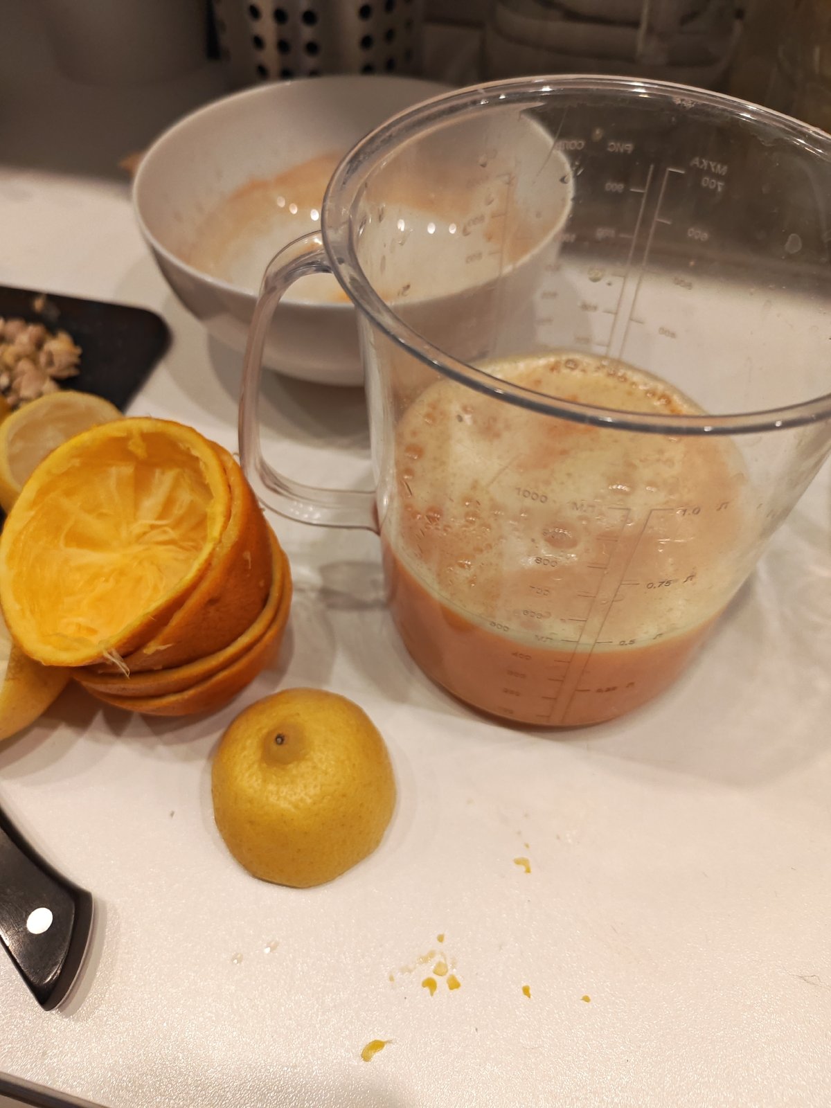 Citrus prep in the kitchen while two cats roam nearby