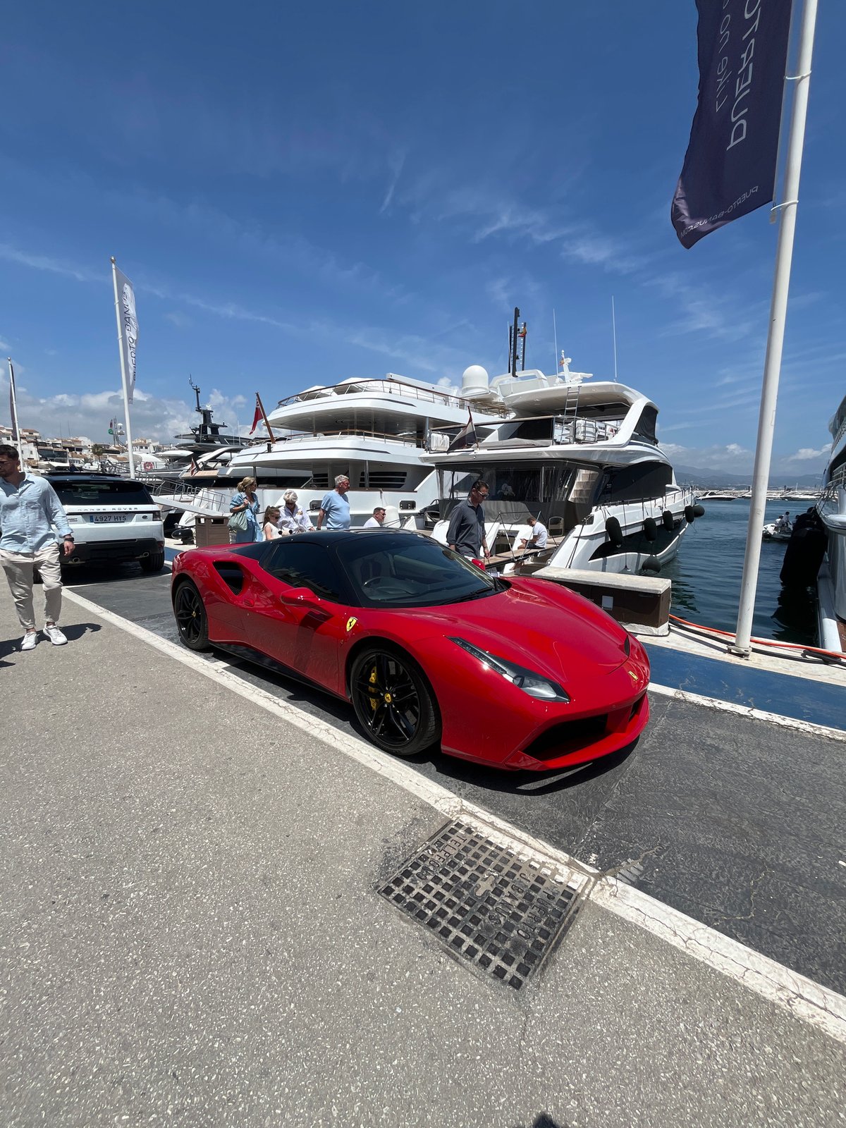 Luxury cars gather at Puerto Banús marina in Marbella